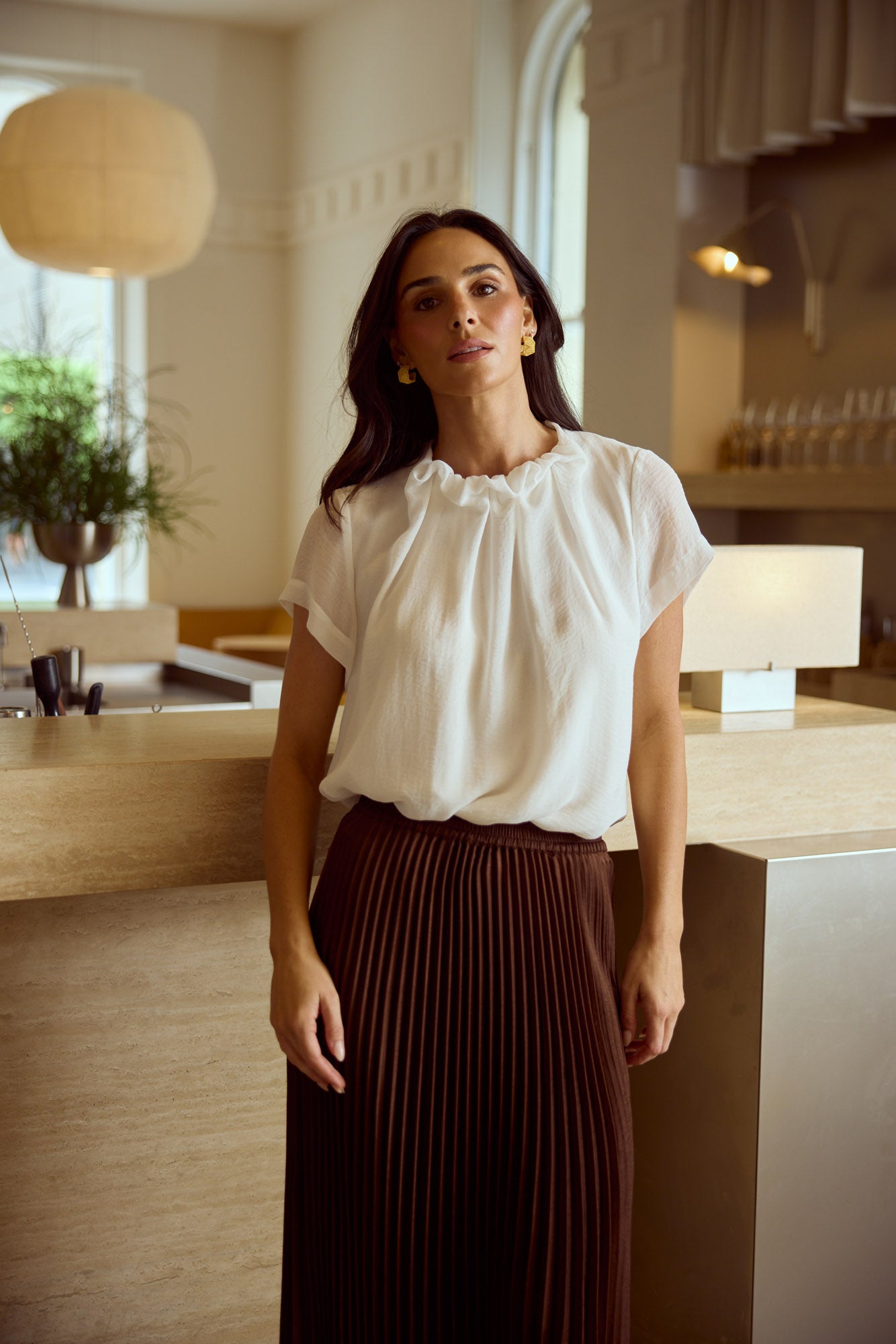 Model styling Carina Blouse in White by Brave + True, campaign lifestyle look.