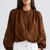 Model wearing Tiana Shirt in bronze brown by Brave + True, front view showing embroidered sleeves.