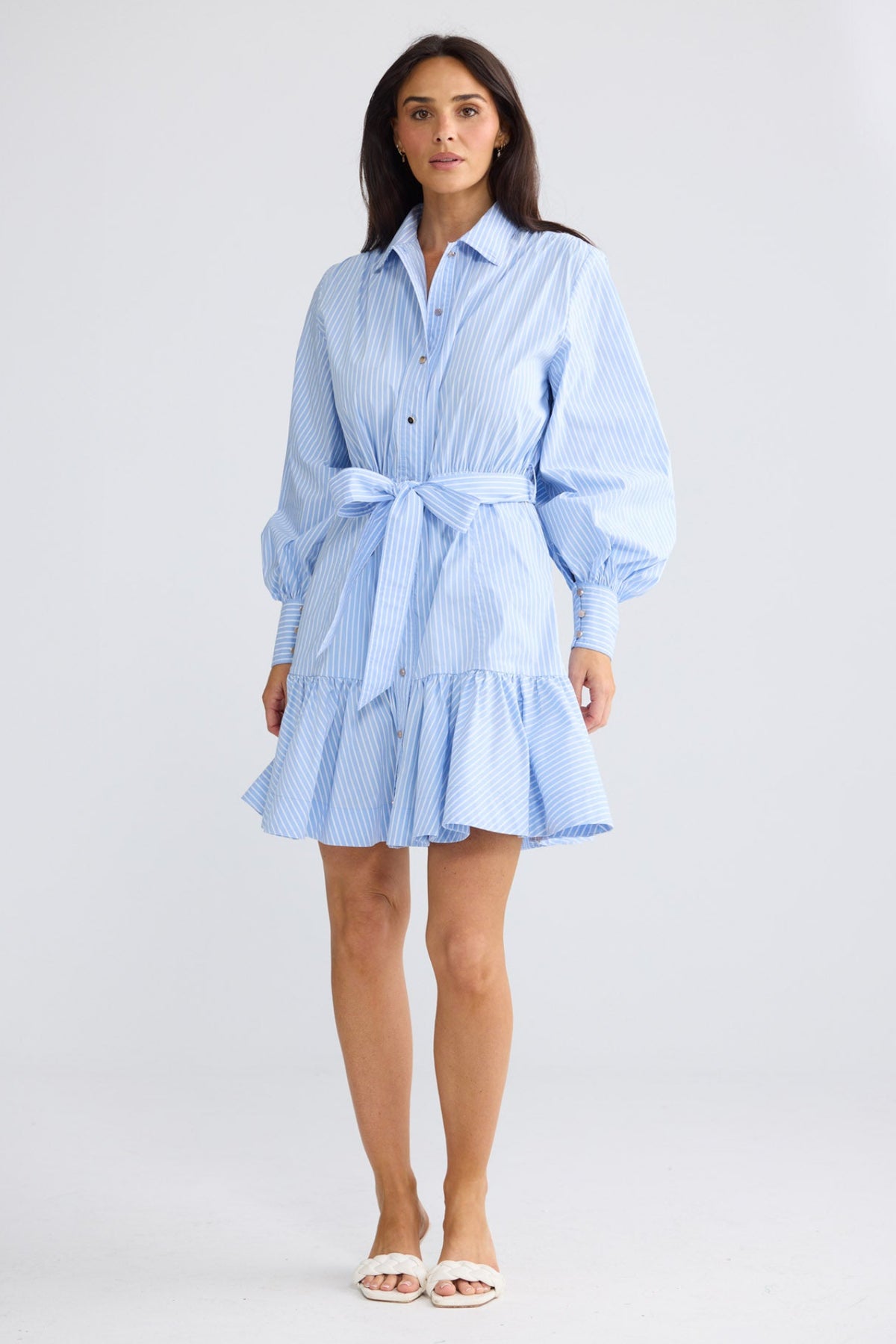 Model wearing Everett Dress in glacier stripe by Brave + True, front view showing waist tie.