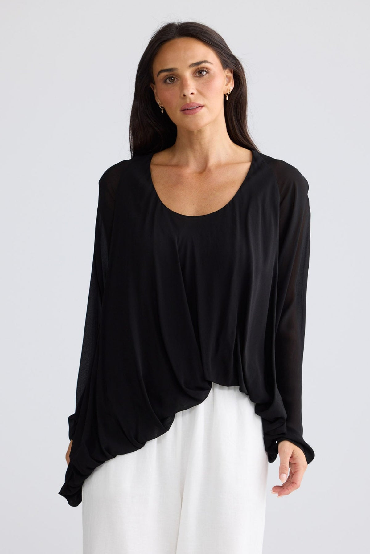 Model wearing Melissa Top in black by Brave + True, front view showing draped front.