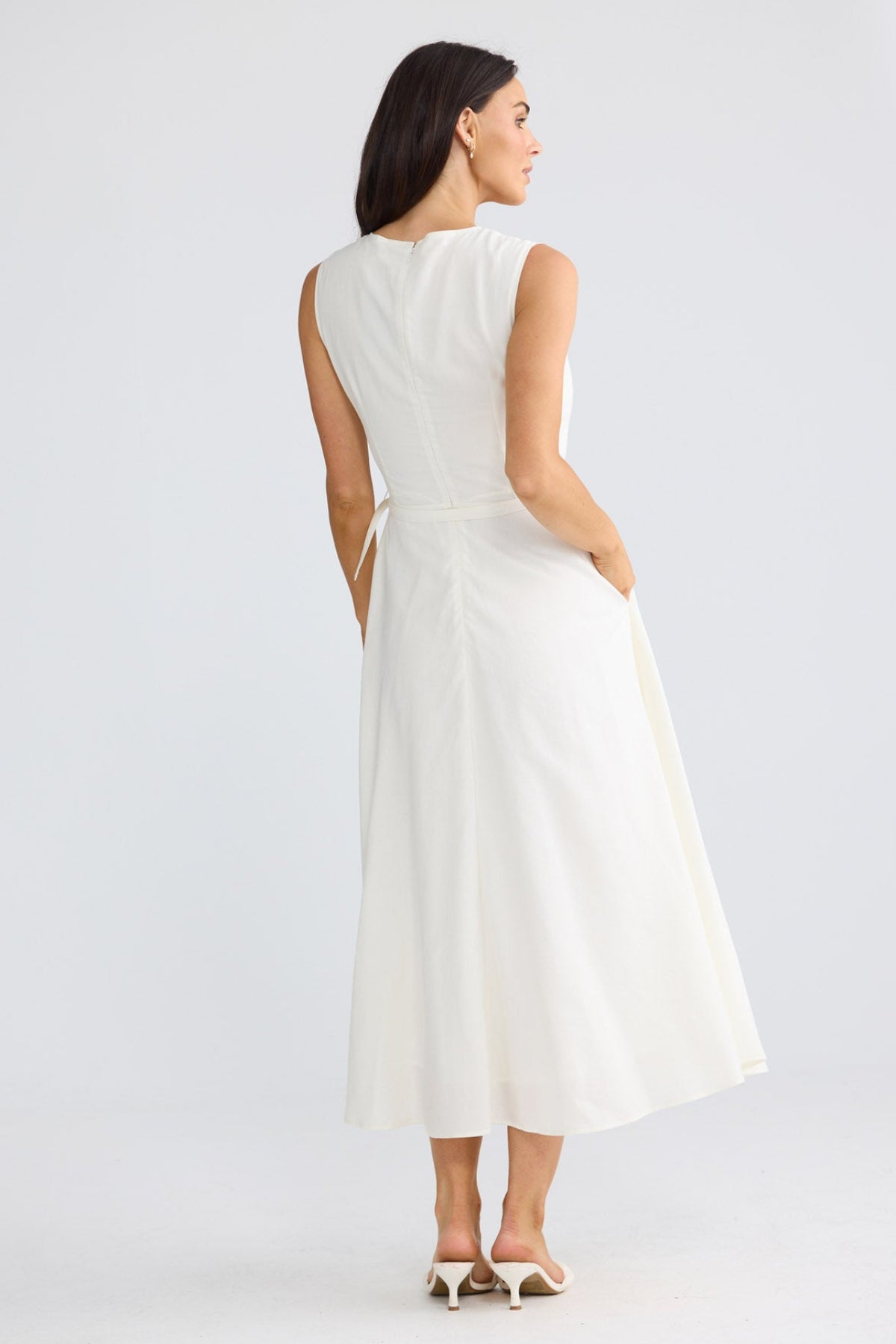 Model wearing Ren Midi Dress in porcelain beige by Brave + True, front view showing waist belt.