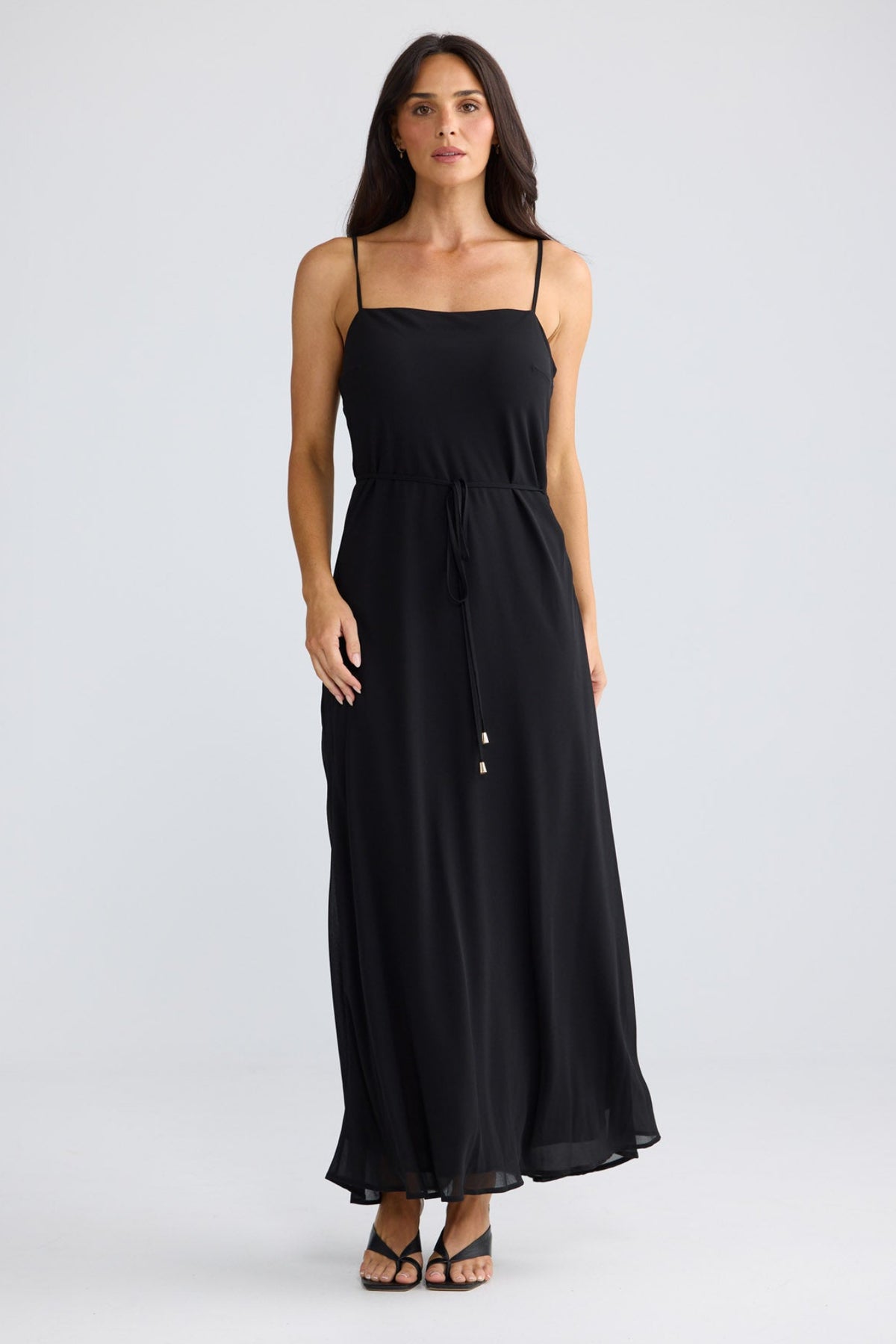 Model wearing Elsbeth Maxi Dress in black by Brave + True, front view showing square neckline.