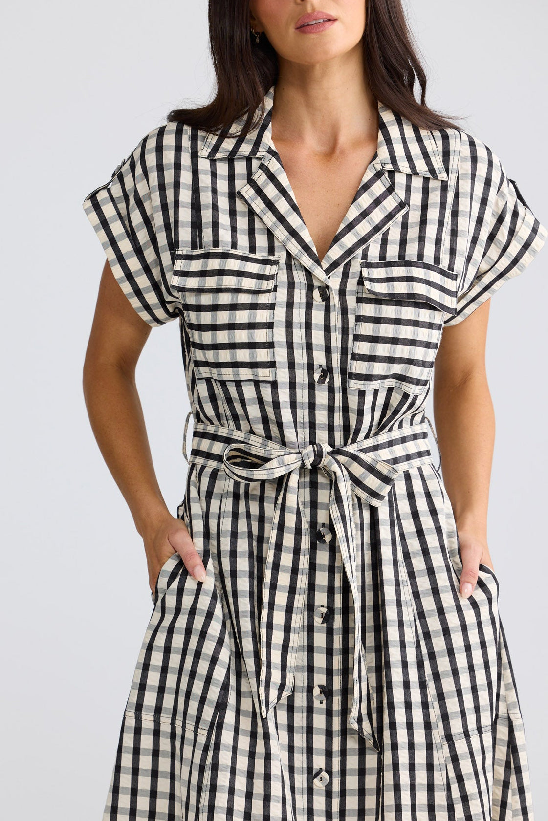 Model wearing Portia Dress in black gingham by Brave + True, front view.
