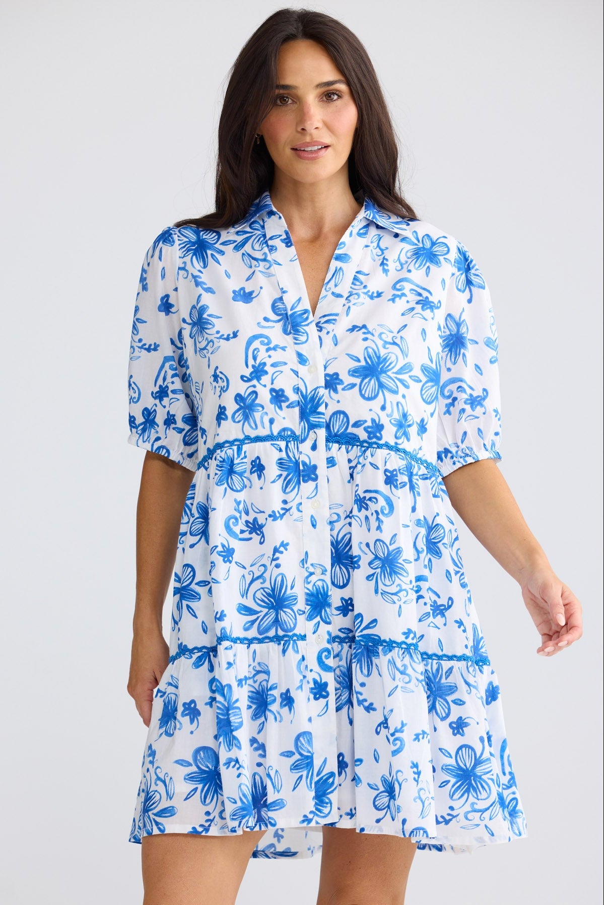 Model wearing Rachel Short Dress in blue bliss floral print by Brave + True, front view.