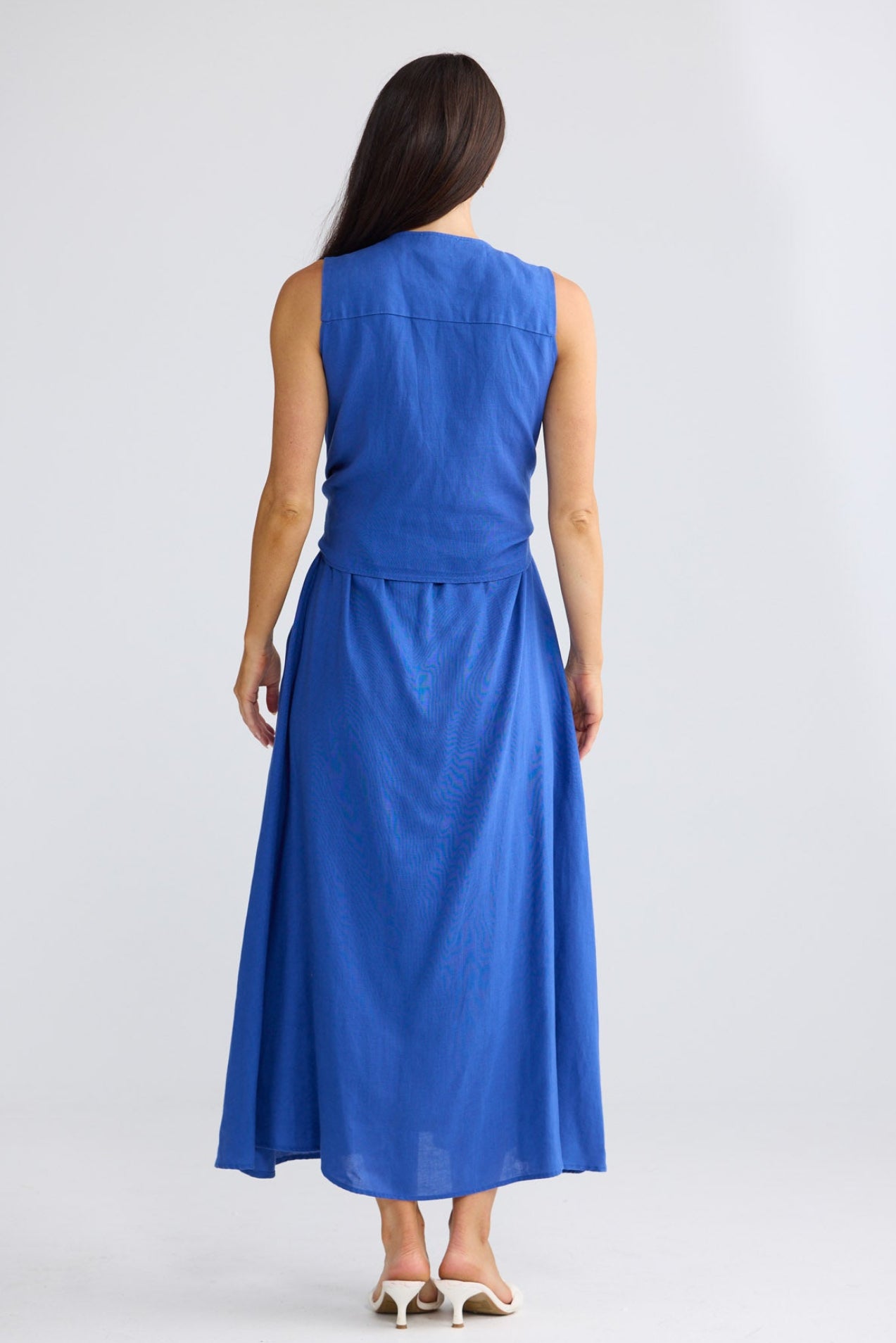 Model wearing Kelsey Dress in cobalt blue by Brave + True, front view showing wrap bodice.