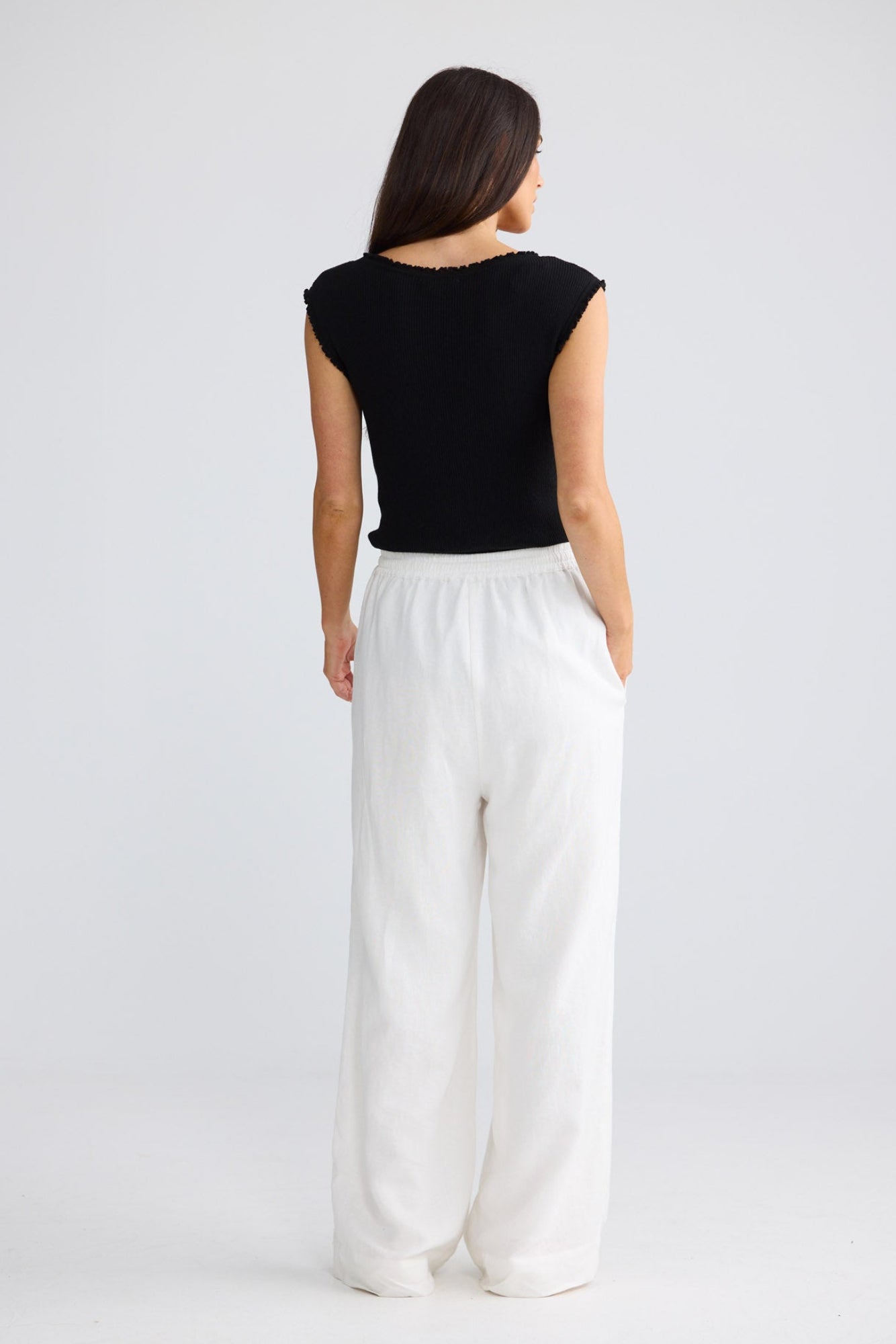 Model wearing Jude Pant in white by Brave + True, front view showing wide-leg silhouette.