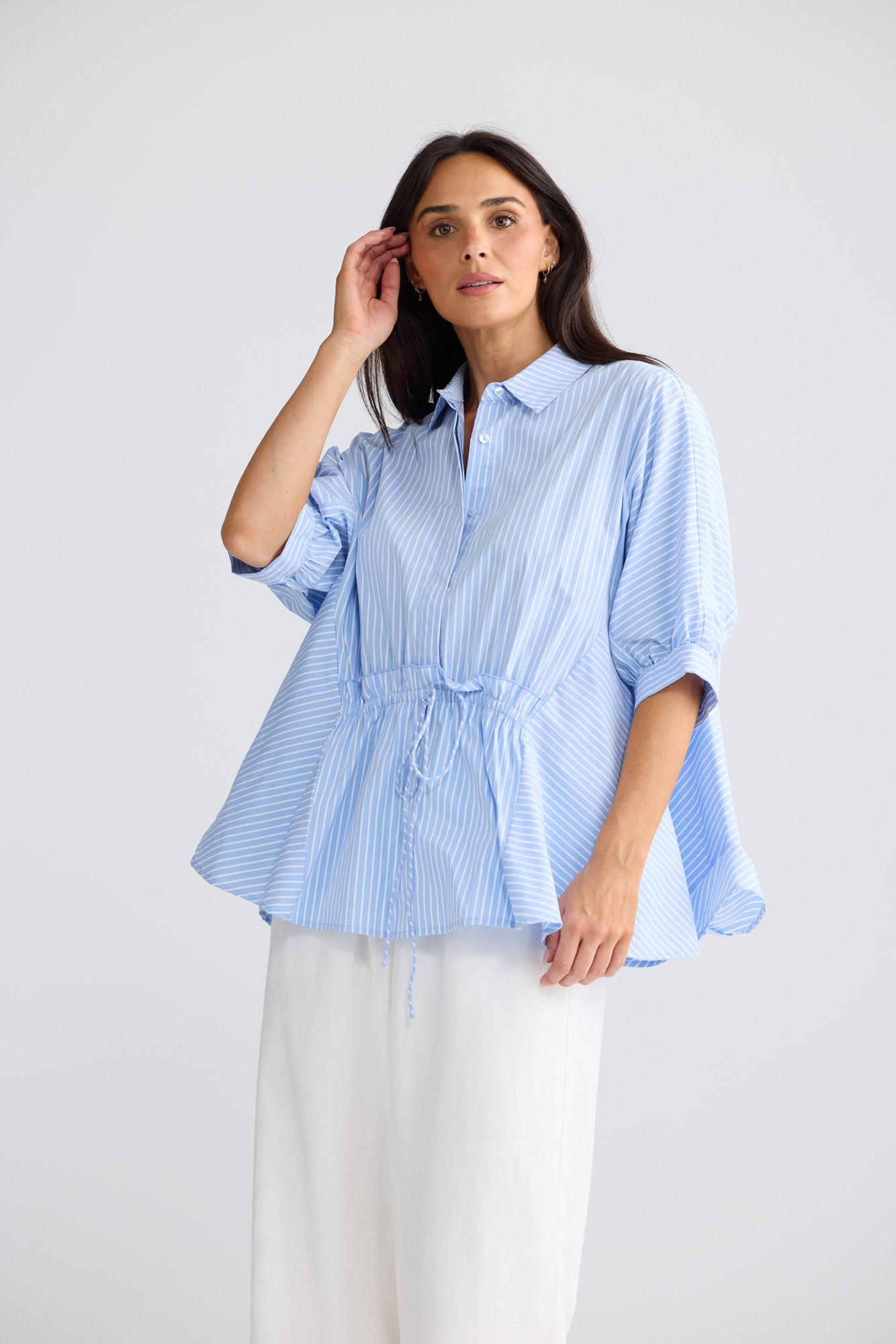 Model wearing Wonderland Top in glacier stripe by Brave + True, front view showing waist tie.