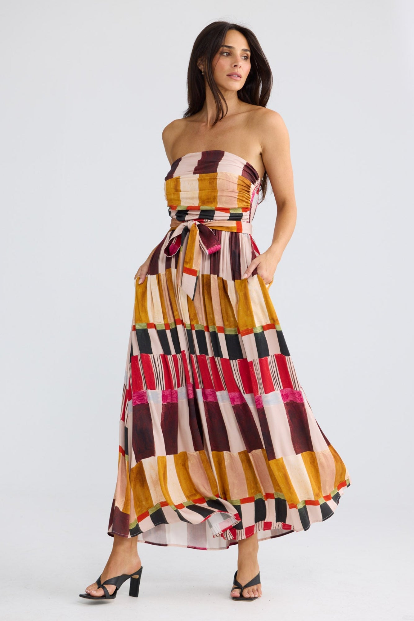 Model wearing Avalon Dress in painterly geo print by Brave + True, front view showing strapless bodice.