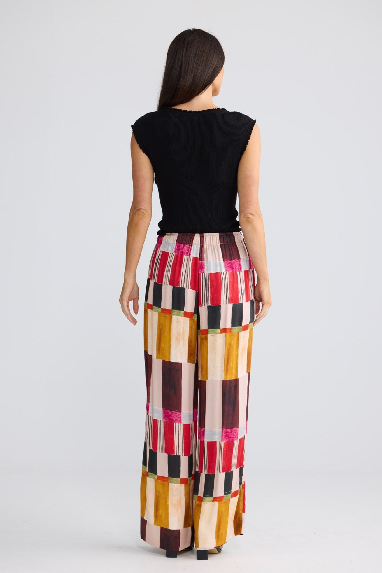 Model wearing Astrid Pant in painterly geo print by Brave + True, front view showing drawcord waist.