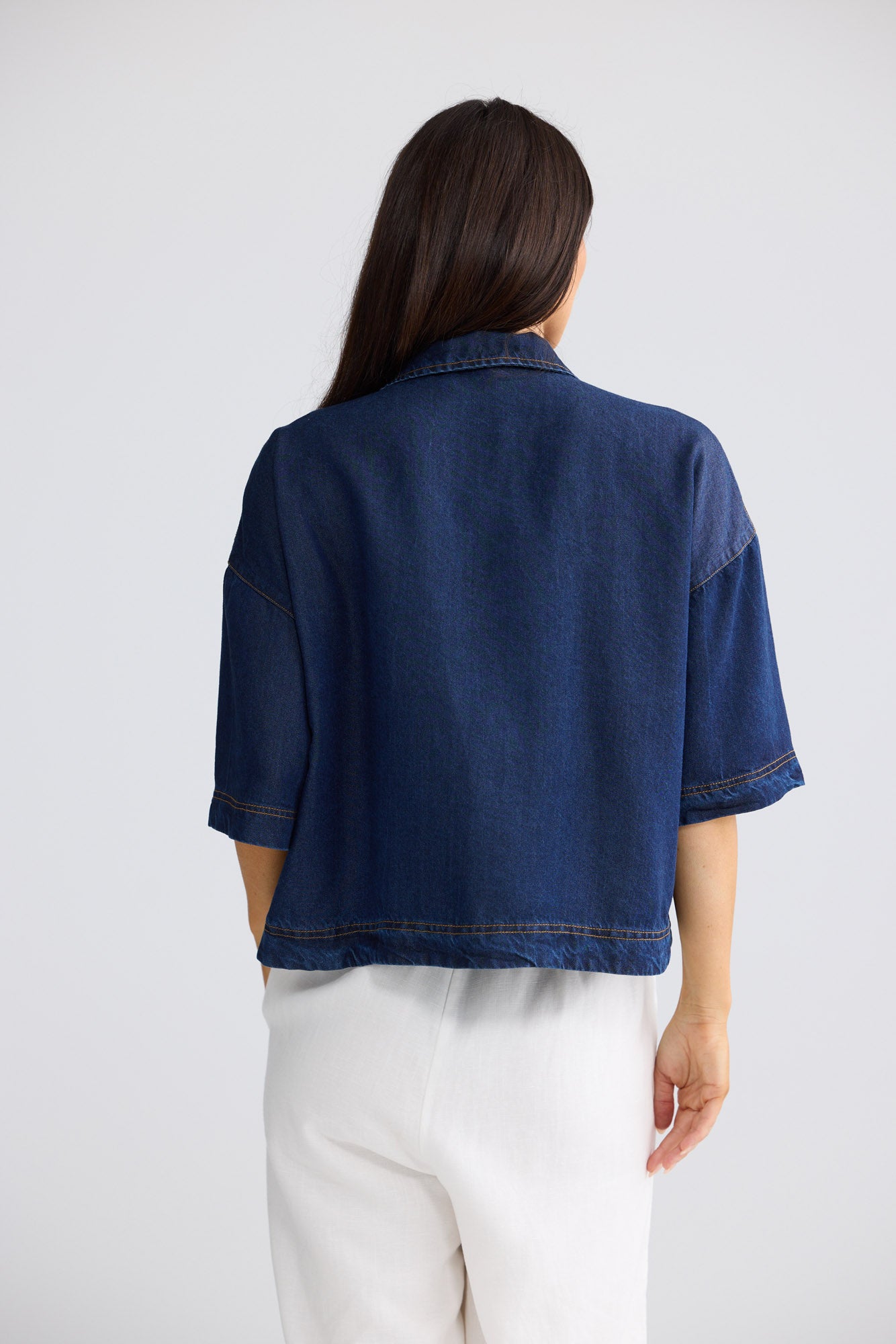 Model wearing Barrymore Shirt in indigo by Brave + True, front view showing cropped silhouette.