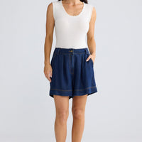 Model wearing Barrymore Short in indigo by brave+true, front view showing wide-leg shorts.