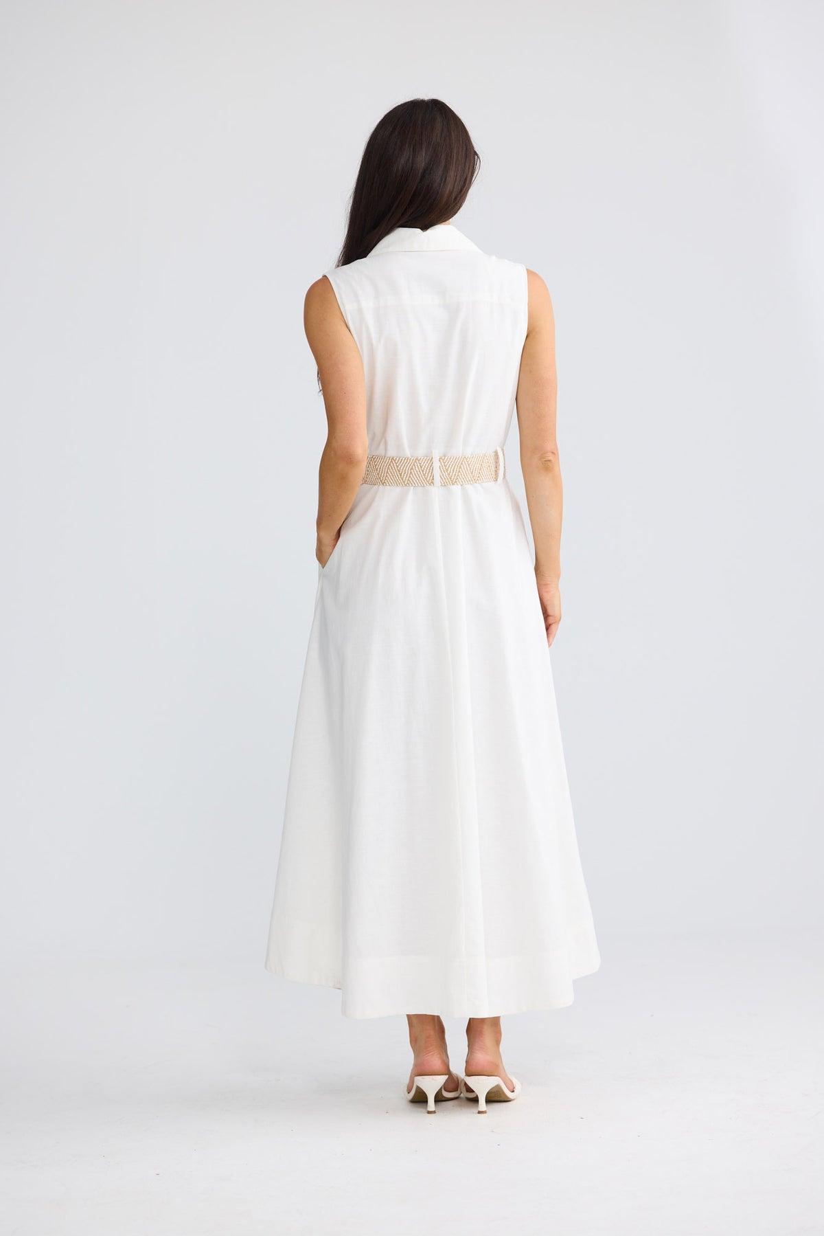 Model wearing Alexis Dress in porcelain by Brave + True, front view showing sleeveless shirt dress.