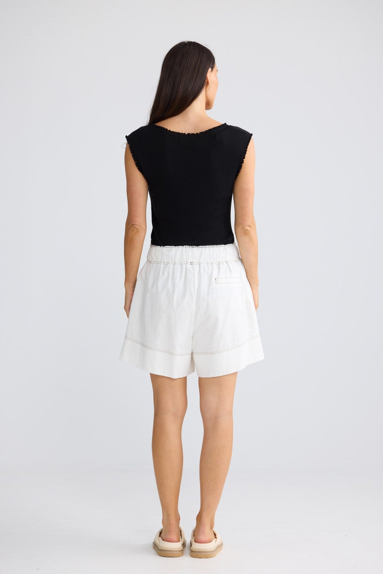 Model wearing Esplanade Short in porcelain by Brave + True, front view showing elasticated waistband.