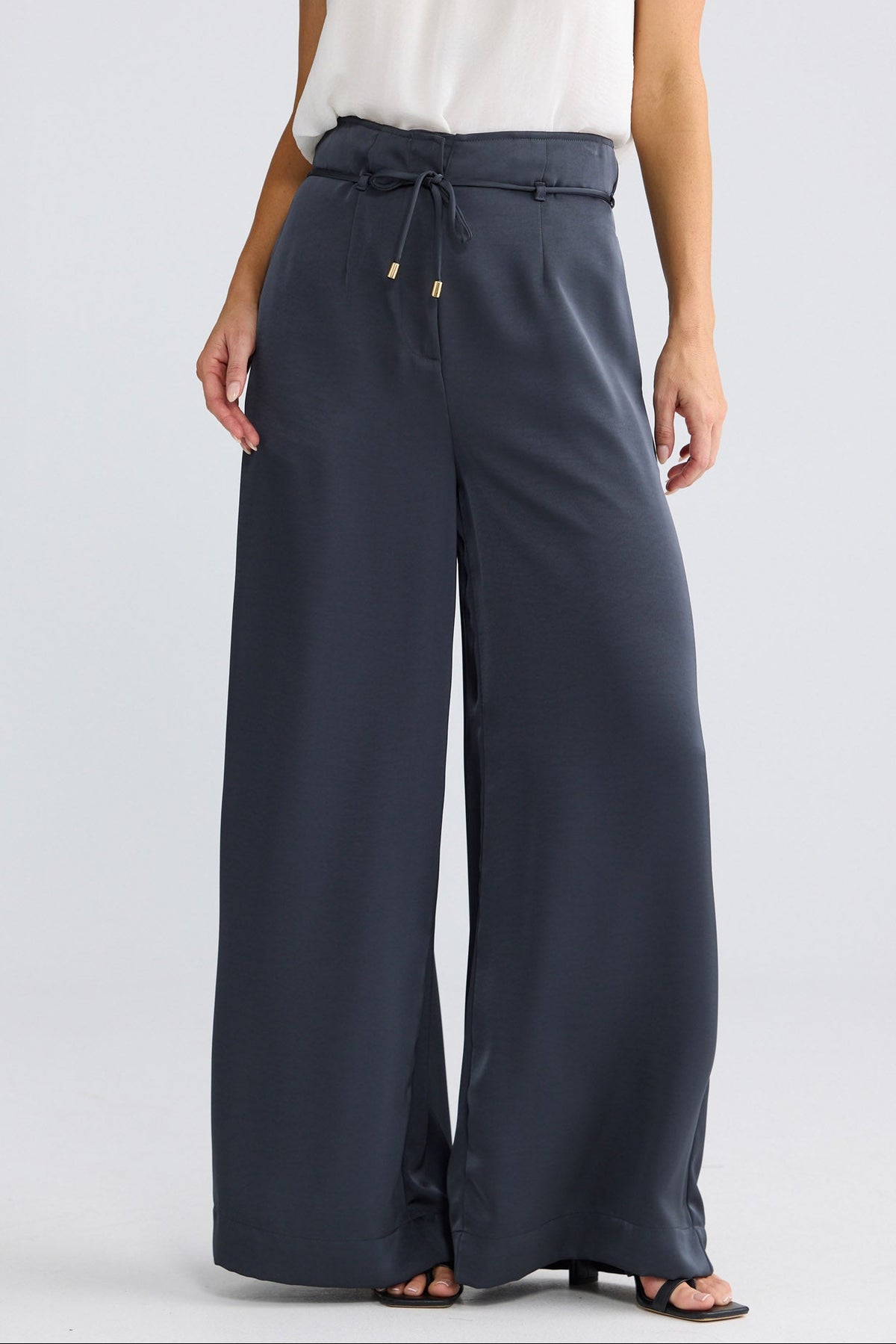 Model wearing Kensington Pant in graphite by Brave + True, front view showing wide-leg silhouette.