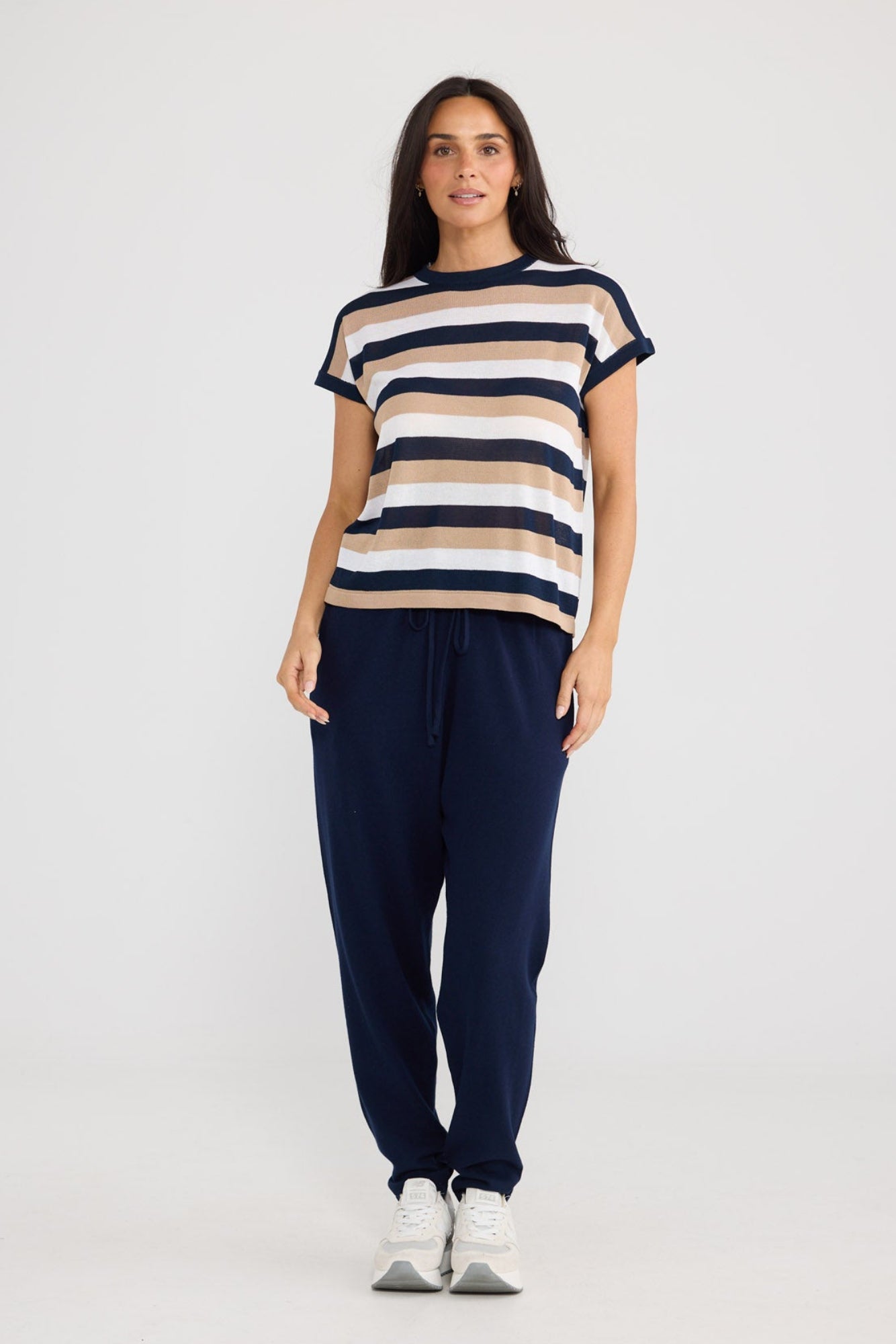 Model wearing Rosalie Tee in navy multi stripe by Brave + True, front view.