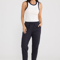 Model wearing Wayfarer Pant in Navy by Brave + True, view 2.