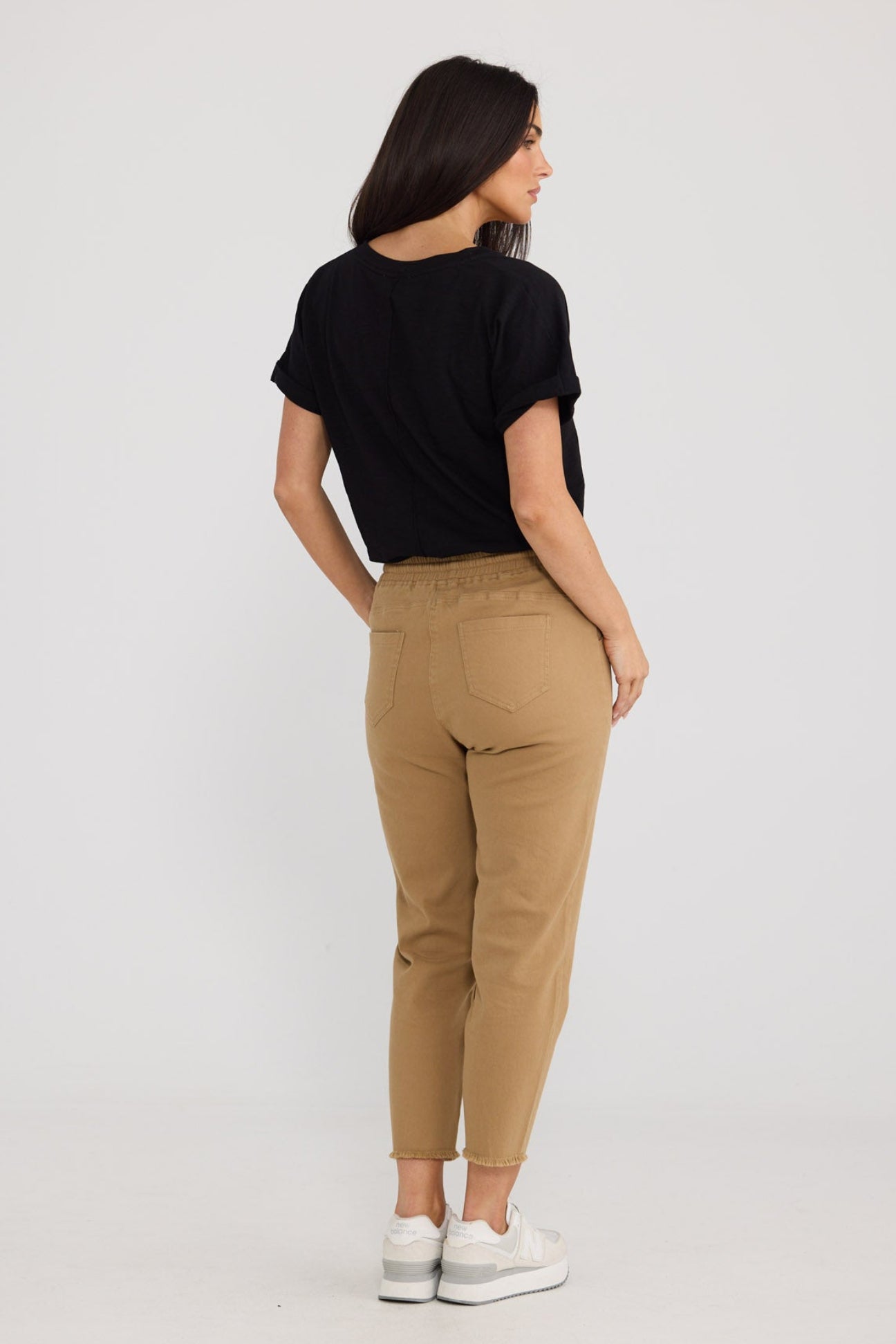 Model wearing Wayfarer Pant in Taupe by Brave + True, view 2.
