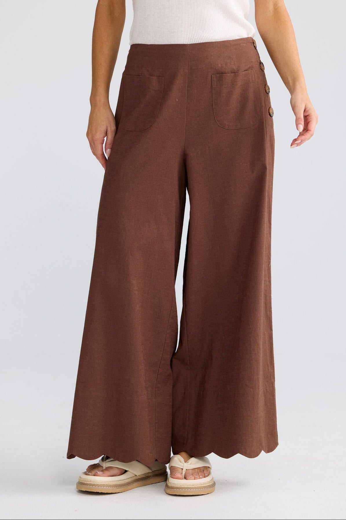 Model wearing Kenzie Pant in coffee by Brave + True, front view with wide leg.