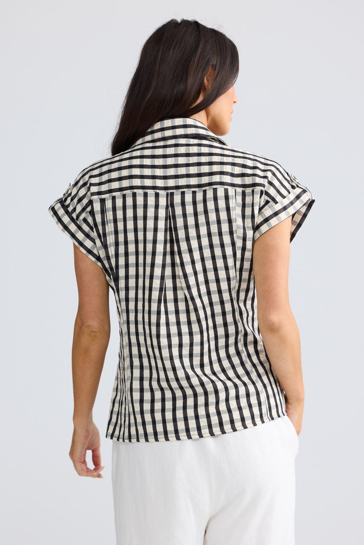 Model wearing Portia Shirt in black gingham by Brave + True, front view with pockets.