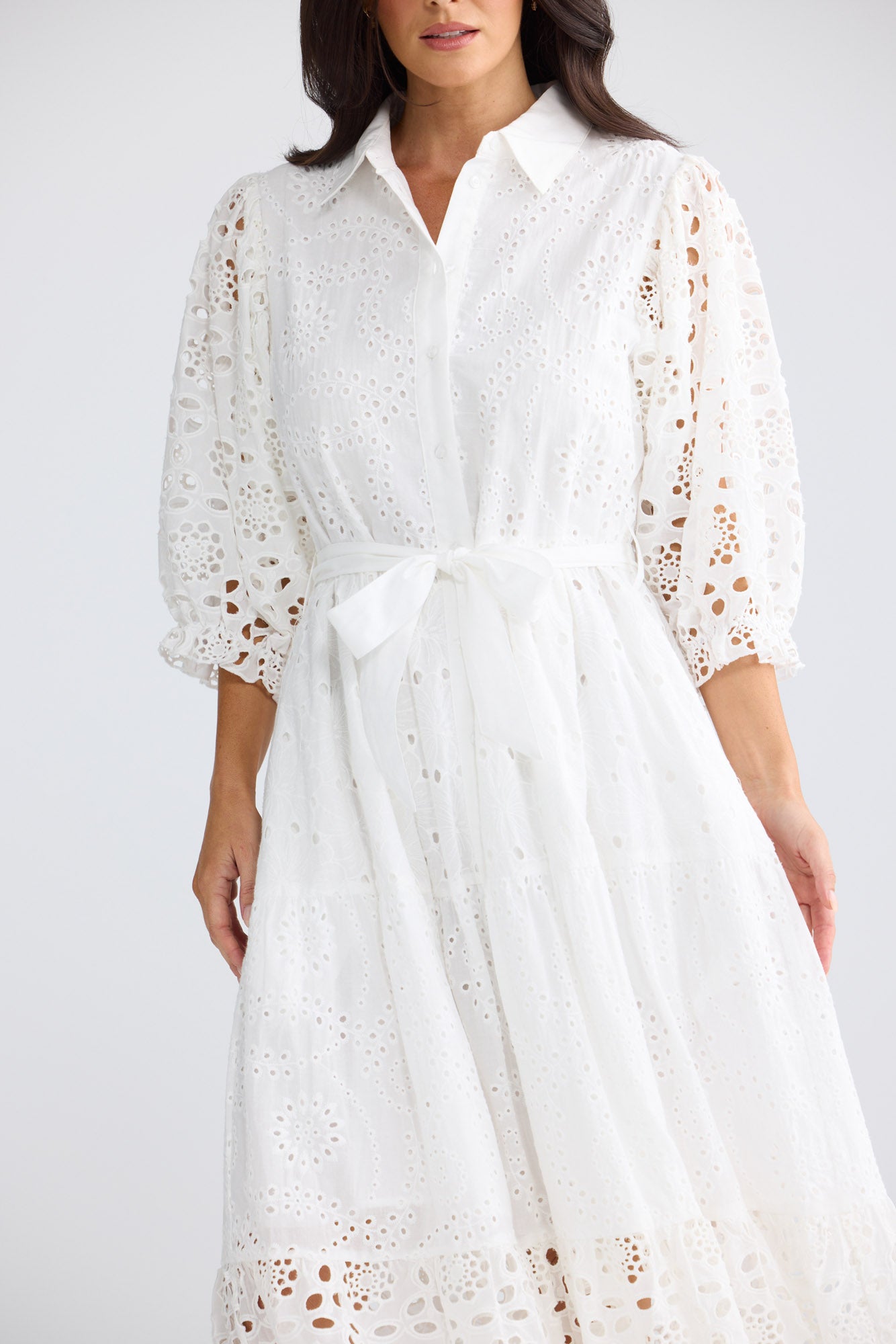 Model wearing Donnie Dress in white by Brave + True, front view with broderie panels.