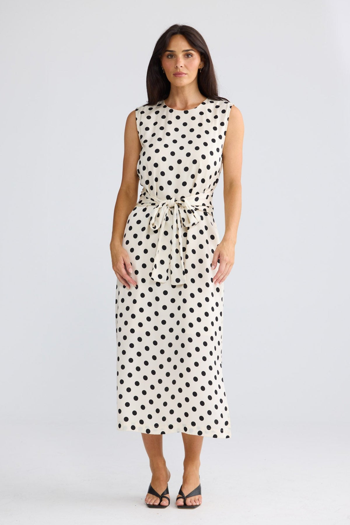 Model wearing Turning Point Dress in ivory spot by Brave + True, front view.