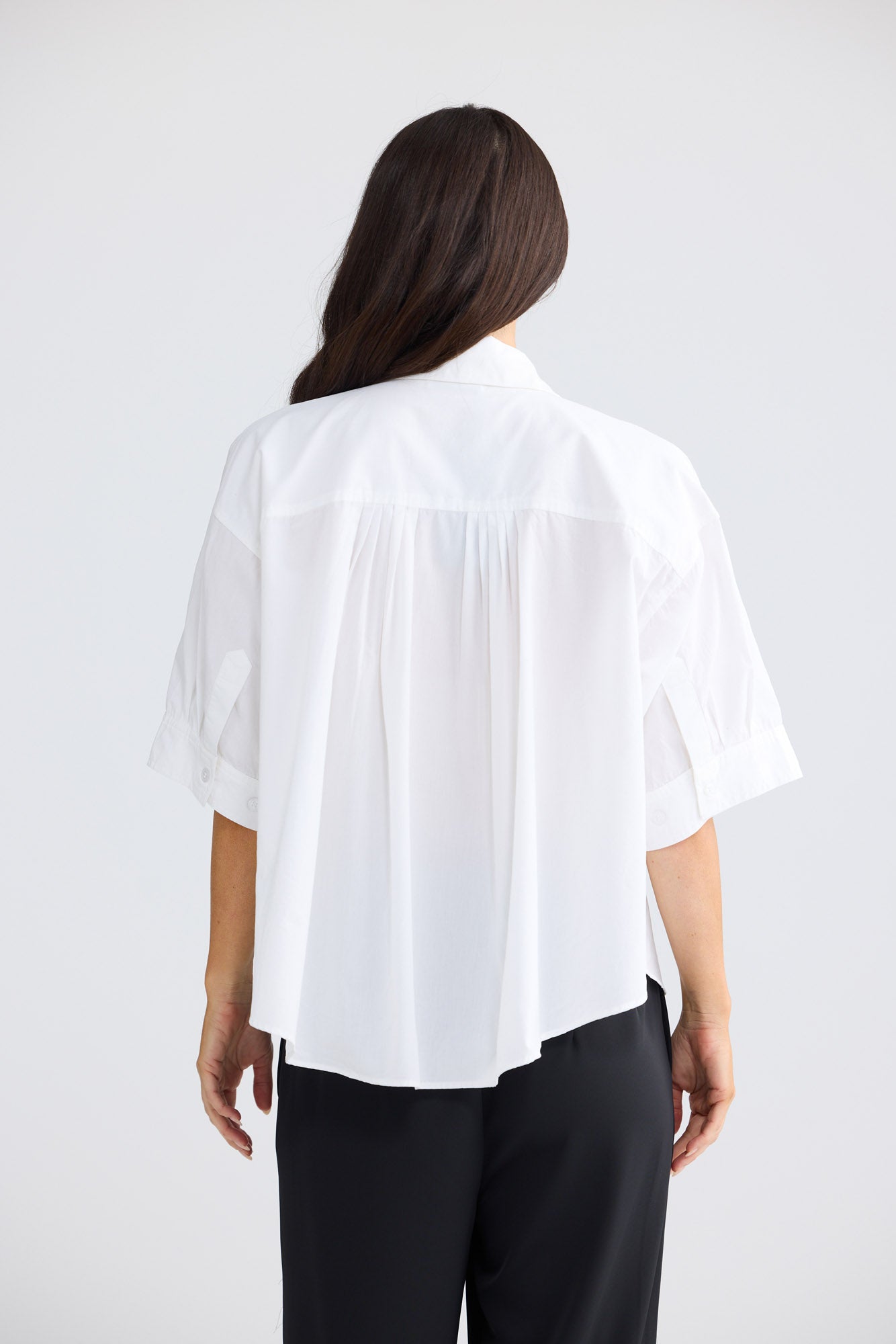 Model wearing Rachel Shirt in white by Brave + True, front view with collared neckline.