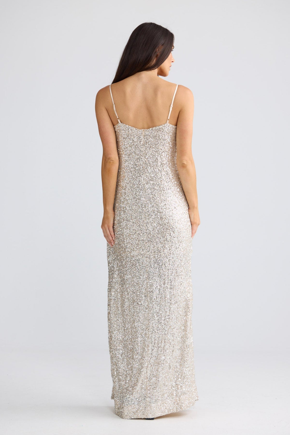 Model wearing Jazzy Maxi Dress in champagne with sequin texture, front view by Brave + True.