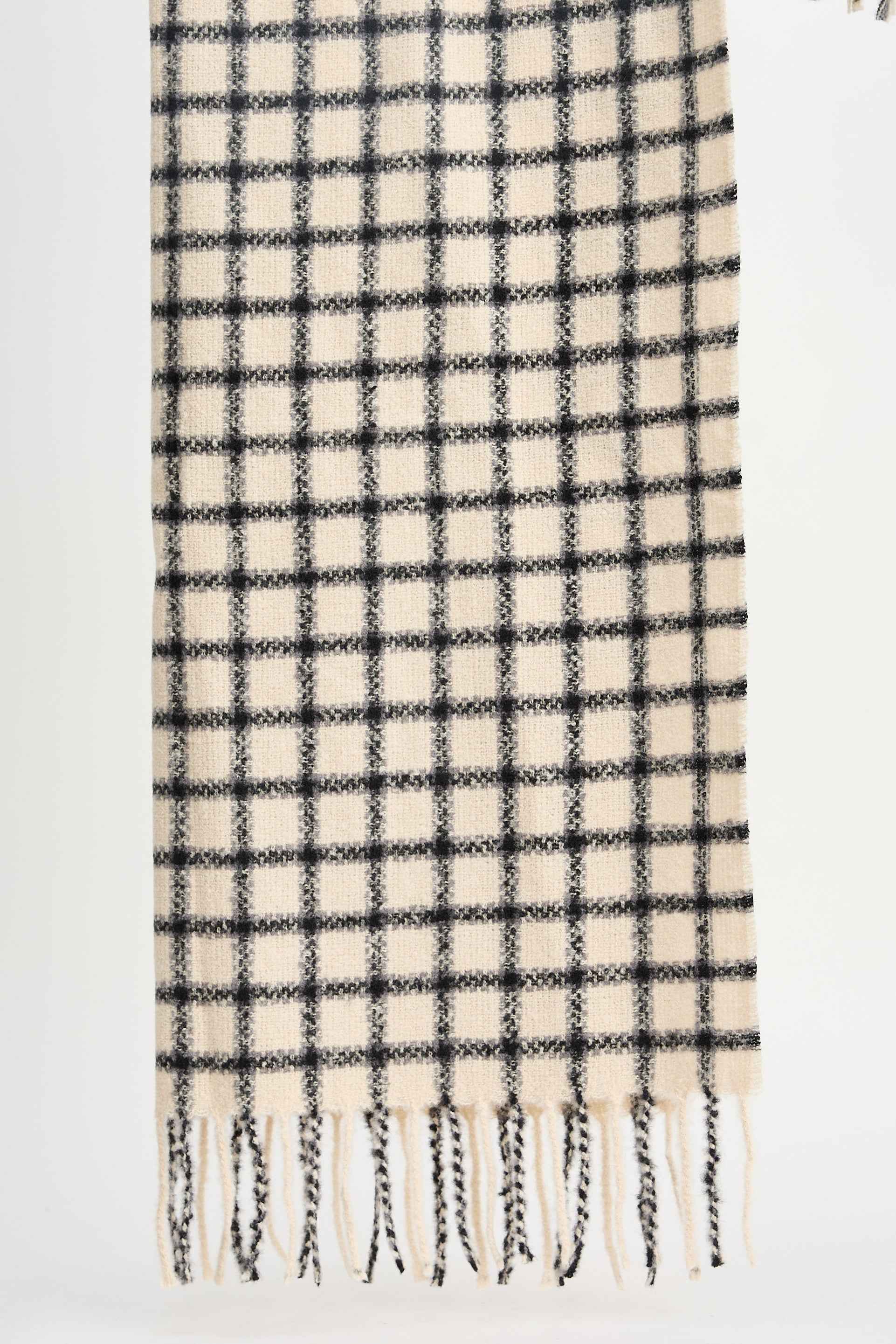Plaid scarf with black and white pattern on a light gray background