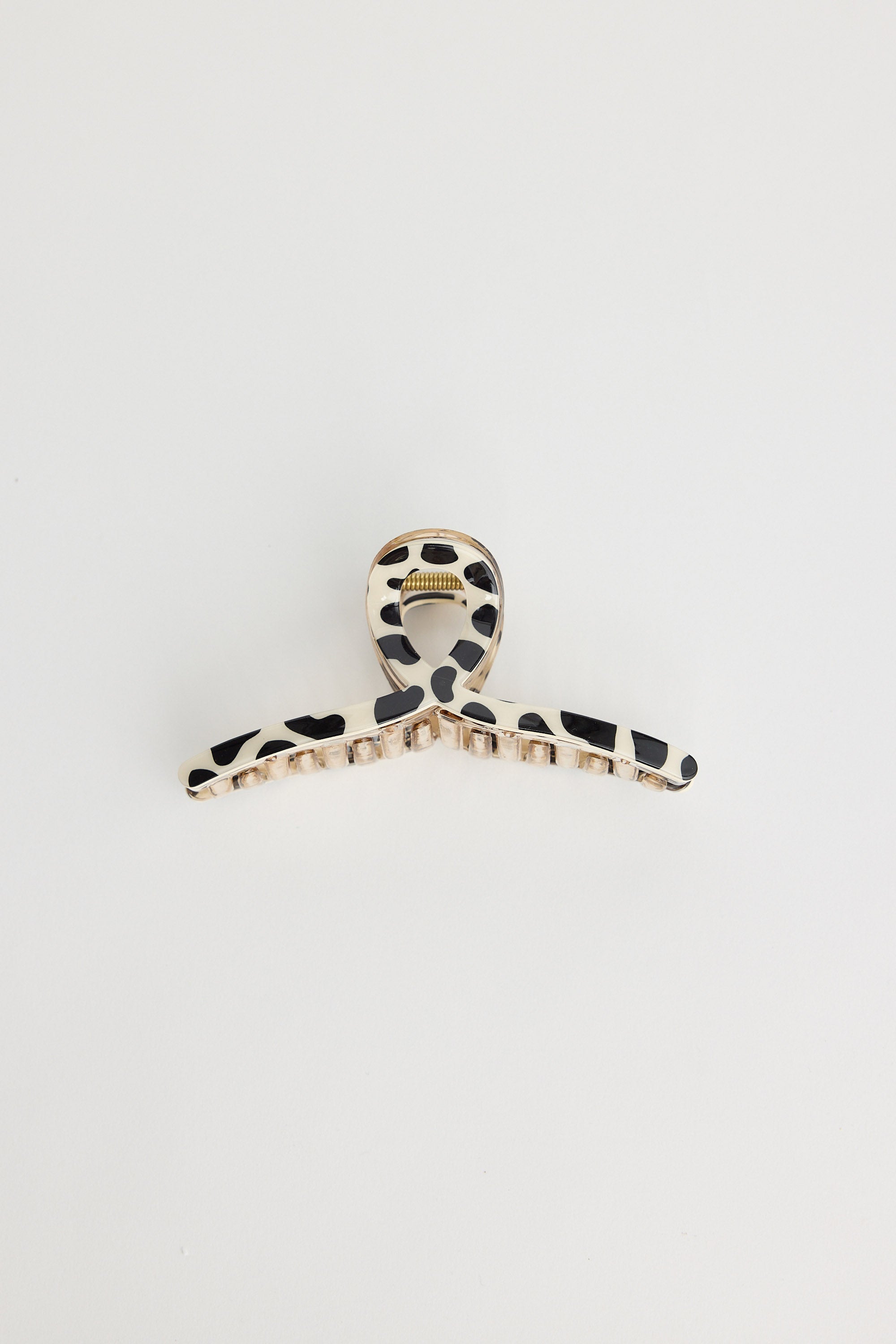 Hair clip with black and white pattern on a light gray background