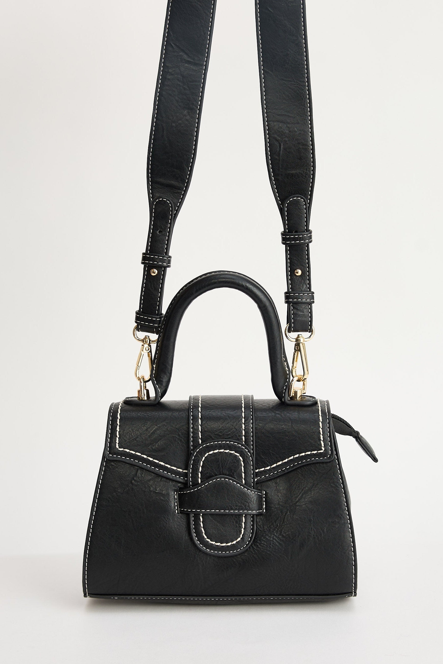 Black handbag with a strap on a white background