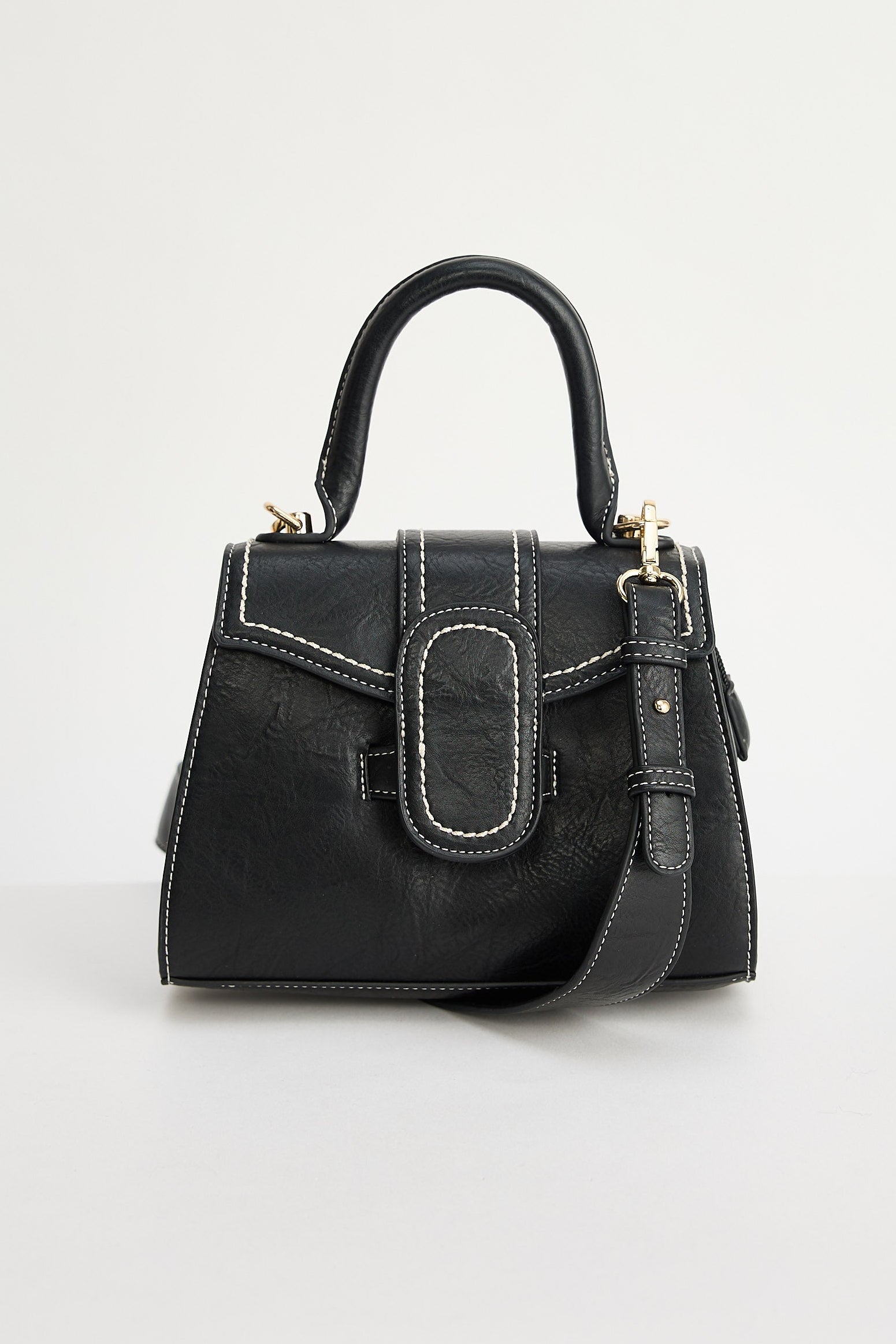 Black handbag with gold accents on a light gray background