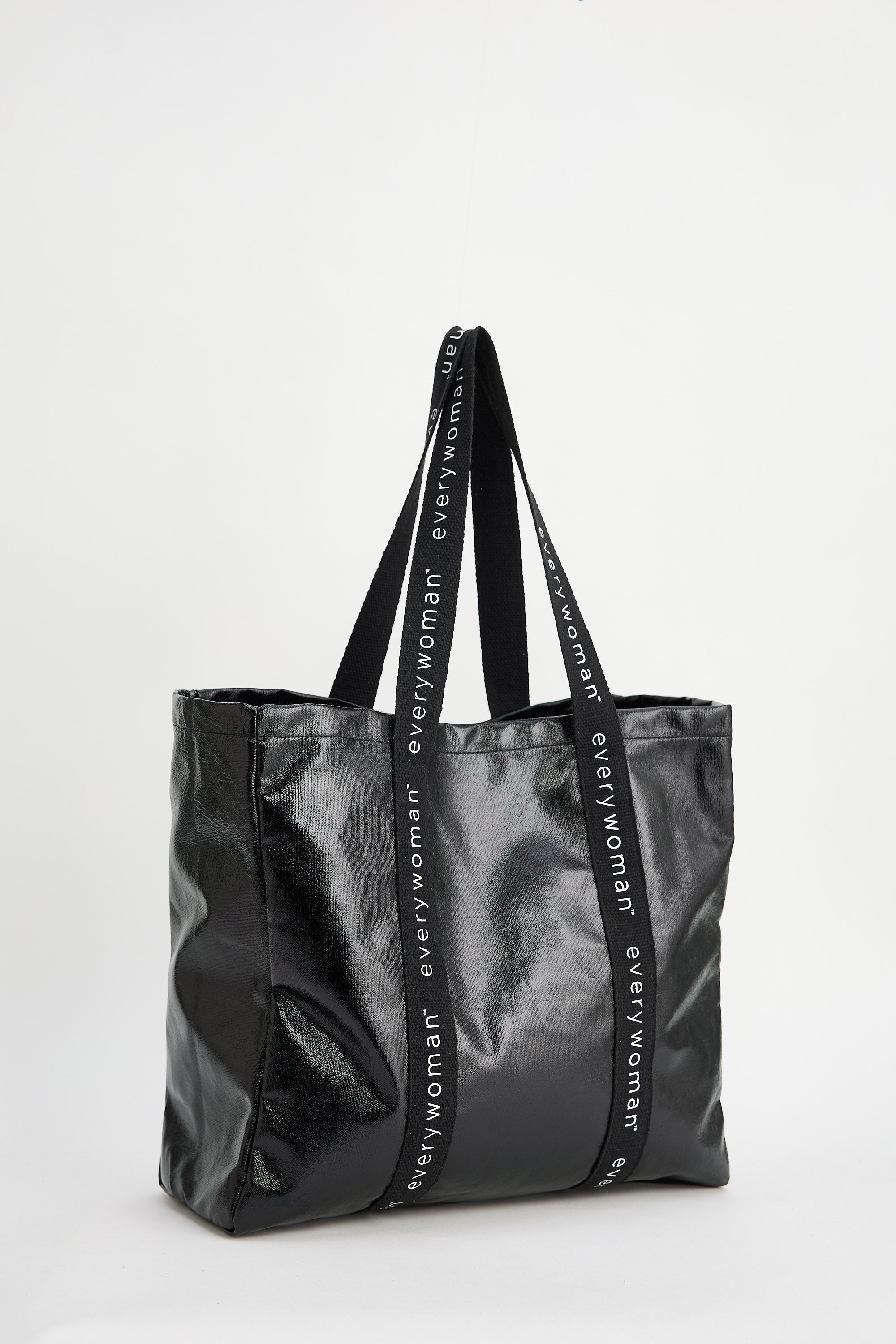 Black tote bag with 'Everywoman' branding on a white background