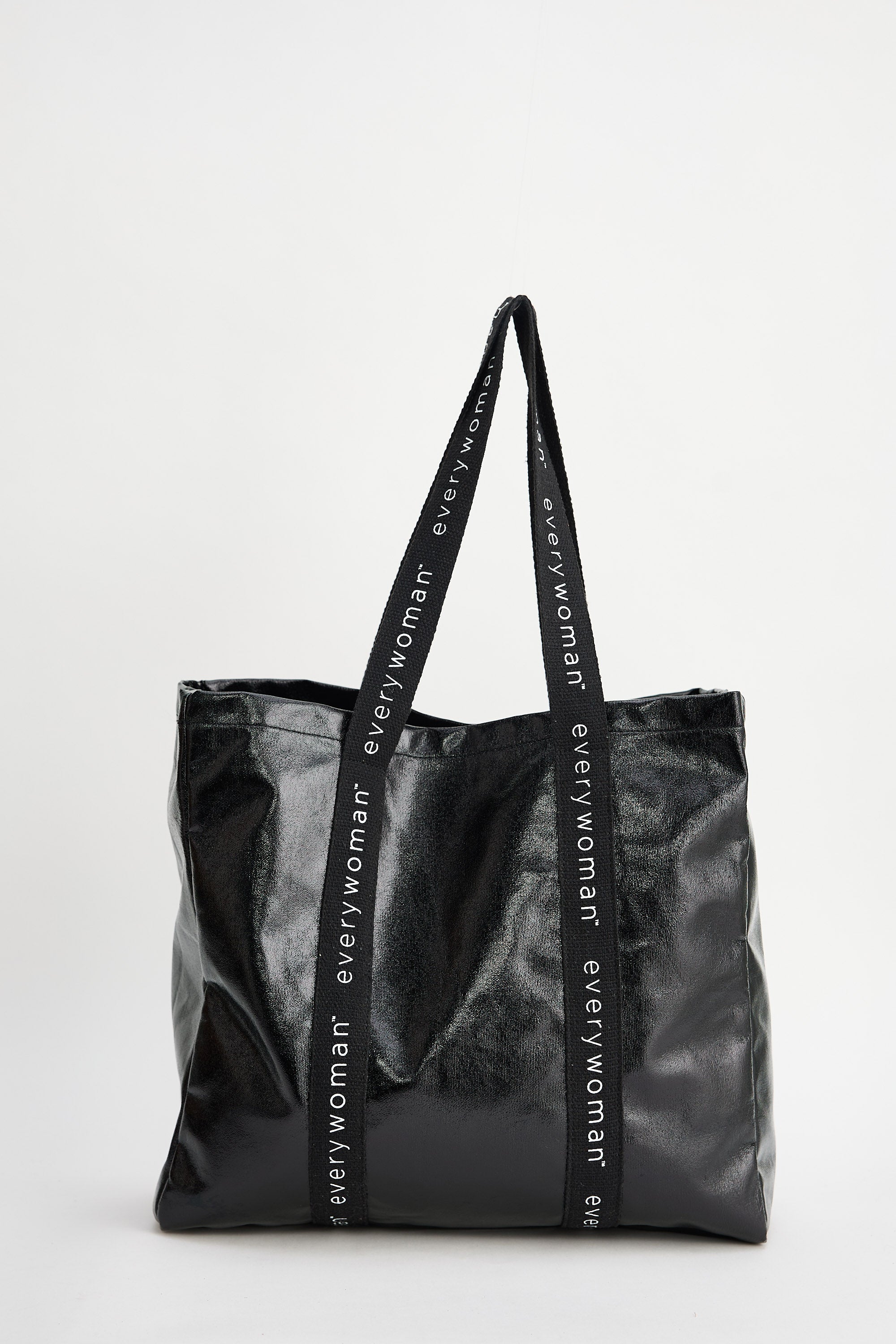 Black tote bag with 'everywoman' branding on a white background