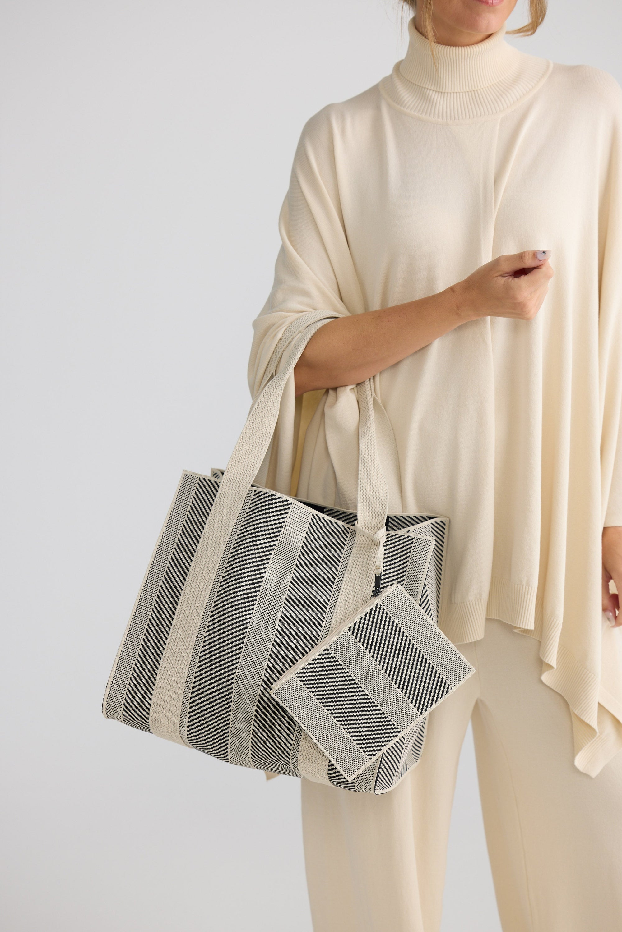 Bellagio Tote Bag - Black tote bag in black with geometric weave, styled view.