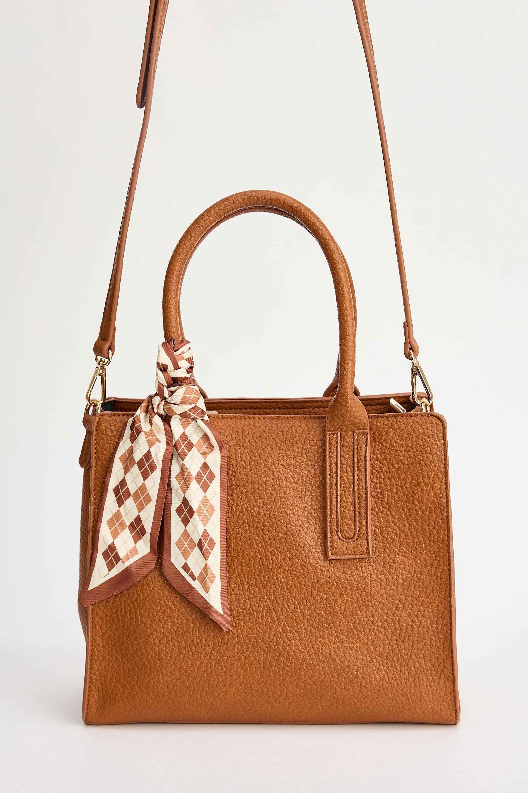 Brown handbag with a checkered scarf on a white background