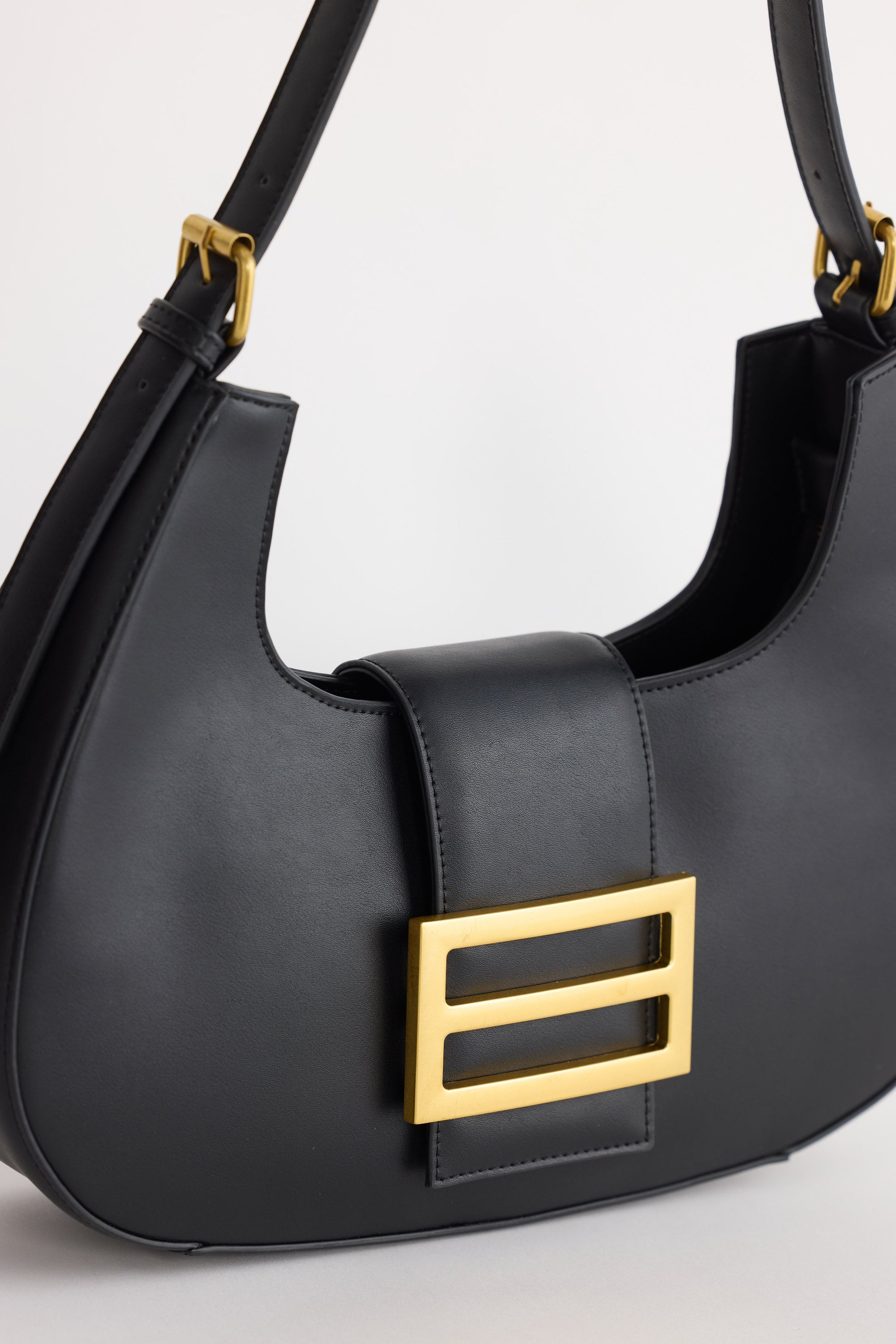 Virginia Handbag - Black handbag in black with gold-tone hardware, alternate view on white background