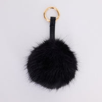 Luna Keyring - Black keyring in black with faux fur pom detail, front view.