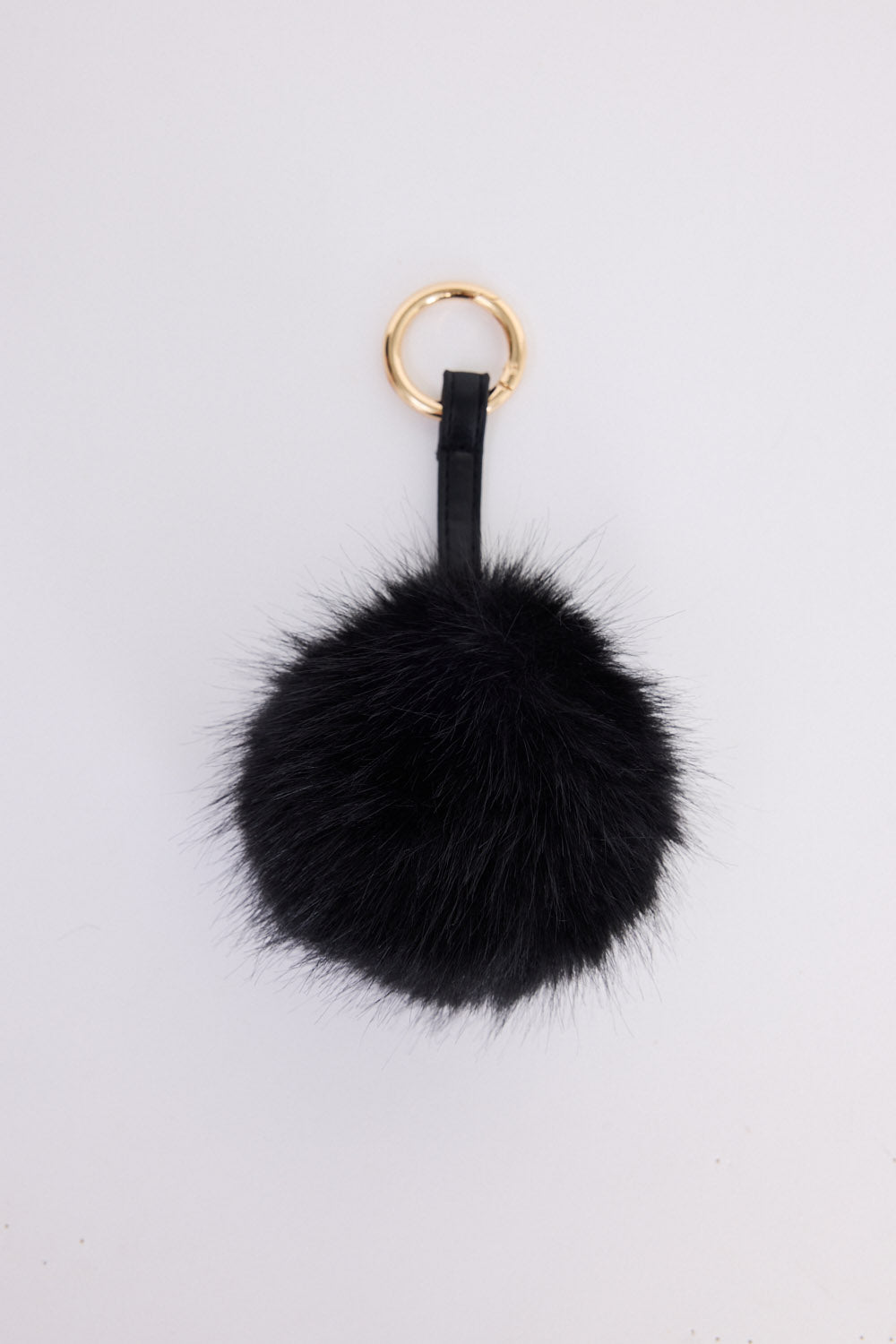 Luna Keyring - Black keyring in black with faux fur pom detail, front view.