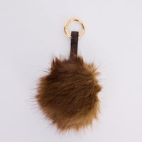 Luna Keyring - Brown keyring in brown with faux fur pom detail, front view.