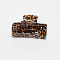 Zali Hair Claw in leopard-print acetate, shown at an angle highlighting the rectangular shape and gold spring hinge