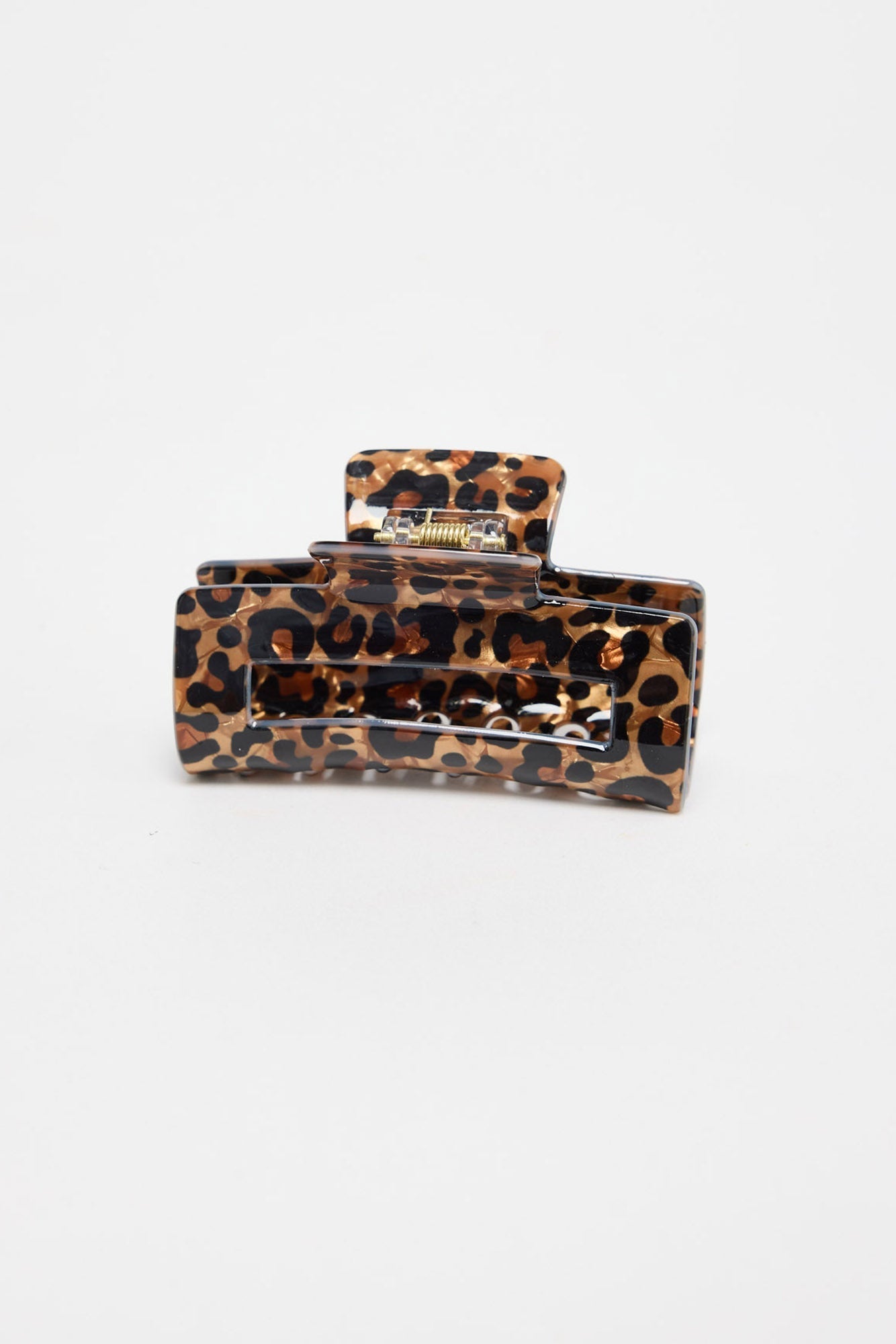 Zali Hair Claw in leopard-print acetate, shown at an angle highlighting the rectangular shape and gold spring hinge