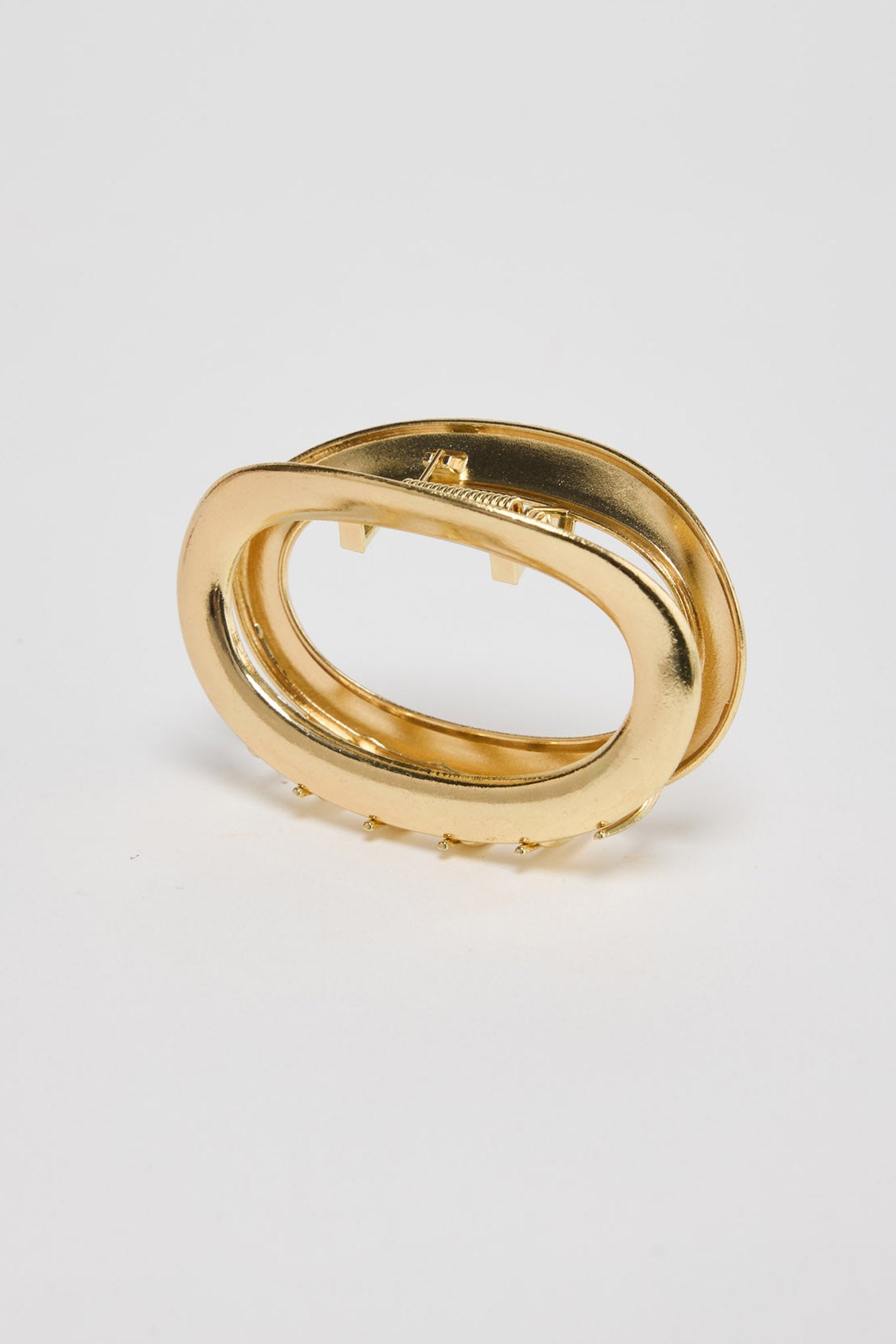 Noosa Hair Claw in gold - angled view of the sleek oval metal hair claw