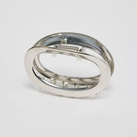 Noosa Hair Claw in silver - angled view of the sleek oval metal hair claw showing the spring hinge