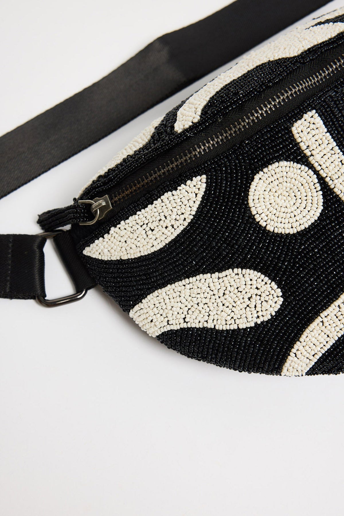 Waves Bumbag in black and white - close-up of the hand-beaded abstract print and zip closure