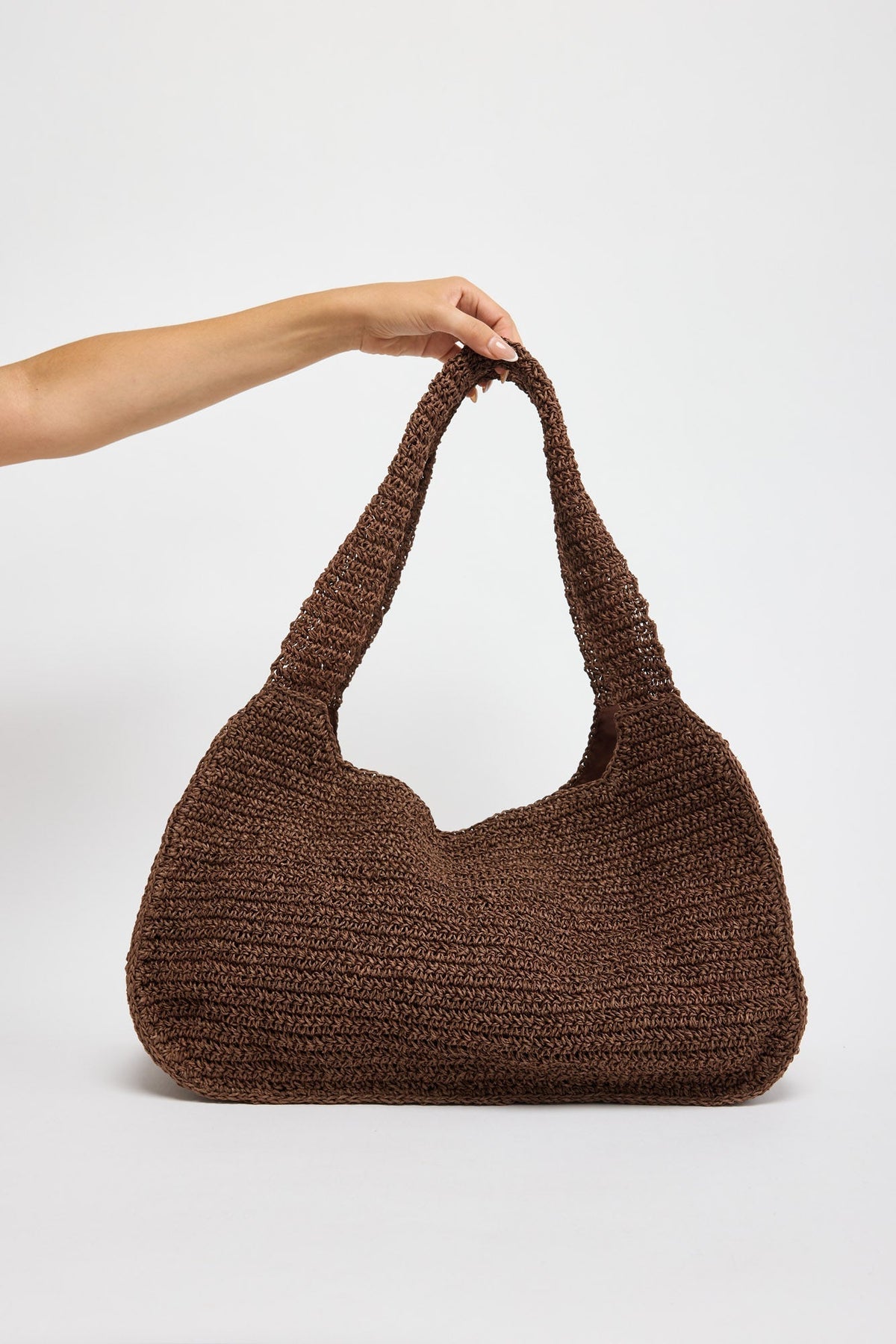 Nora Bag in chocolate brown - side angle view of the crochet shoulder bag