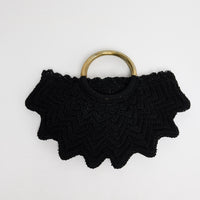 Santana Bag in black - handwoven crochet bag with scalloped chevron edges and brass-tone ring handles, flat lay