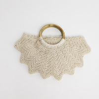 Santana Bag in off white - handwoven crochet bag with scalloped chevron edges and brass-tone ring handles, flat lay