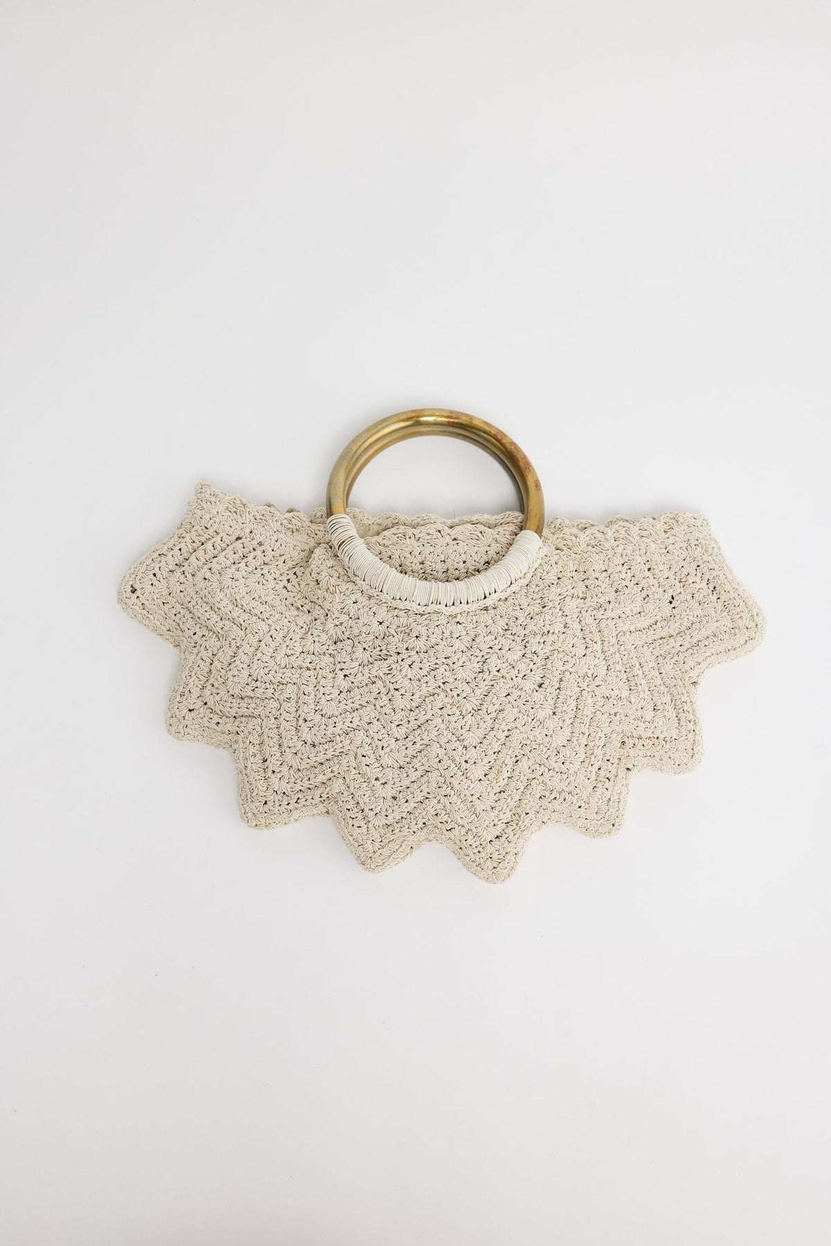 Santana Bag in off white - handwoven crochet bag with scalloped chevron edges and brass-tone ring handles, flat lay