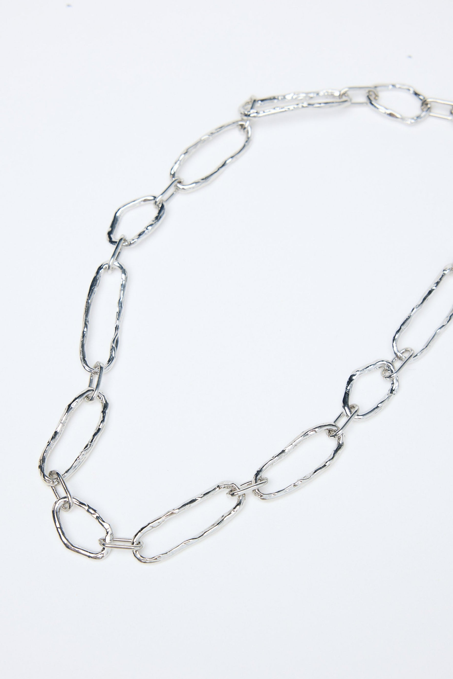 Silver chain necklace on a white background