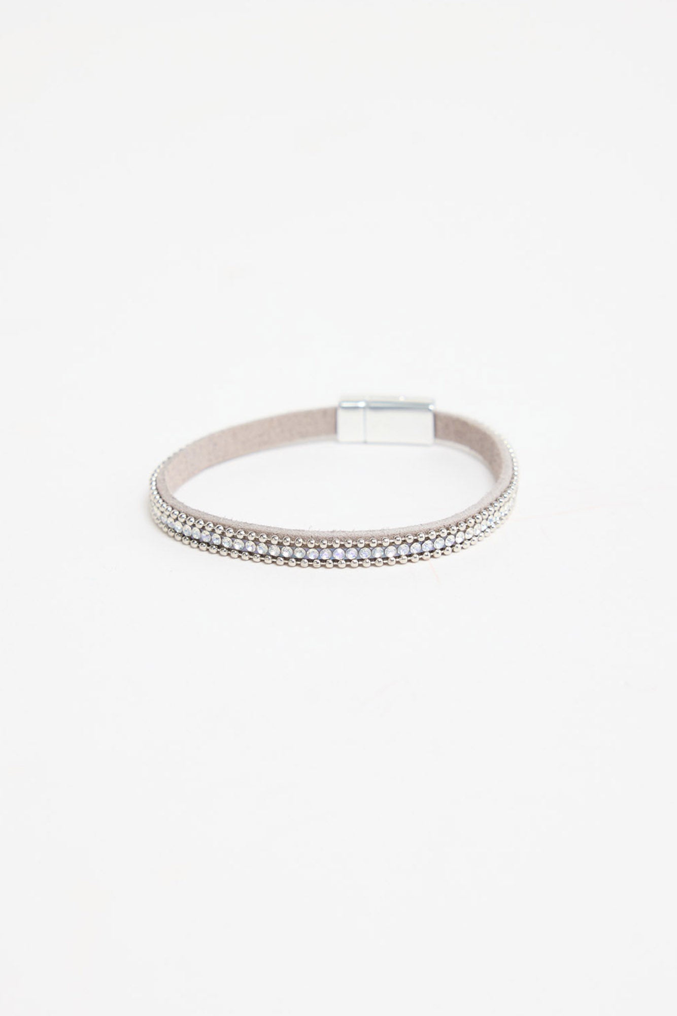 Harper Bracelet in silver-tone finish, showing the grey suede band, row of clear crystals, ball-chain trim and magnetic clasp